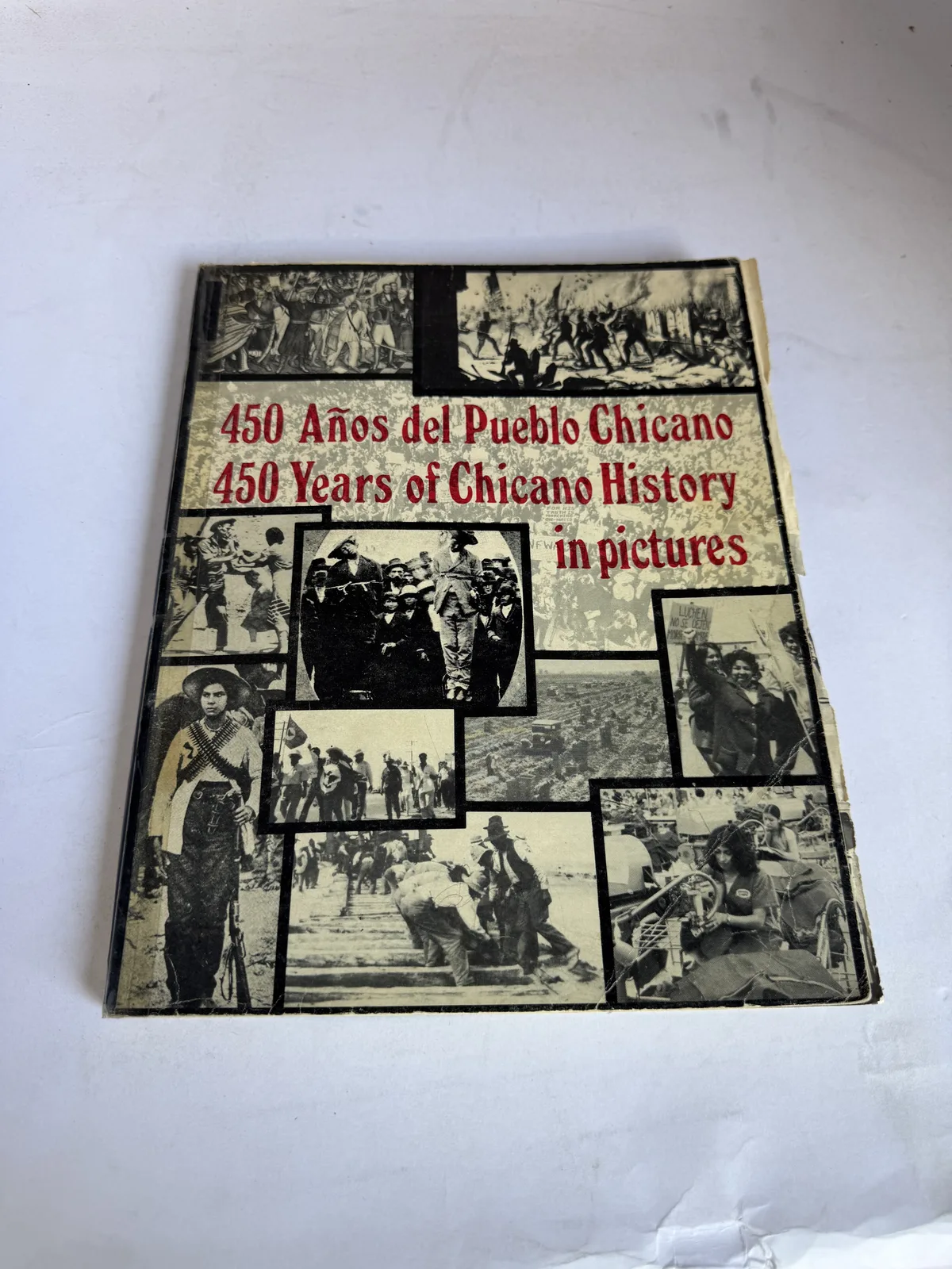 Cover of 450 Anos del Pueblo Chicano, 450 Years of Chicano History in Pictures, a photomontage of historic Chicano images, Chicano Communications Center Albuquerque, photographed at New Mexico Literacy Project