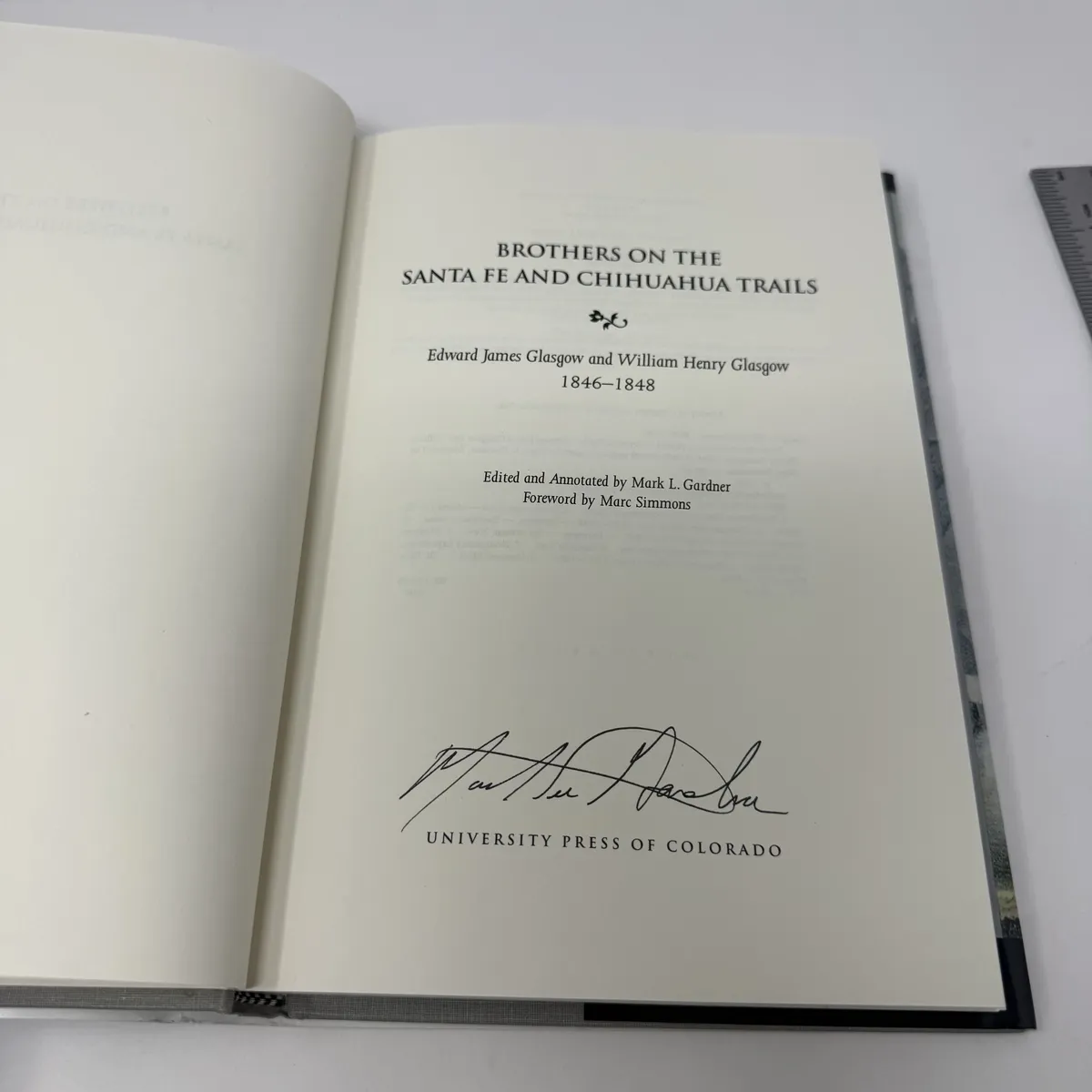 Title page signed by Mark L. Gardner in dark ink beneath the University Press of Colorado imprint, with the editorial credit and Marc Simmons foreword line visible above