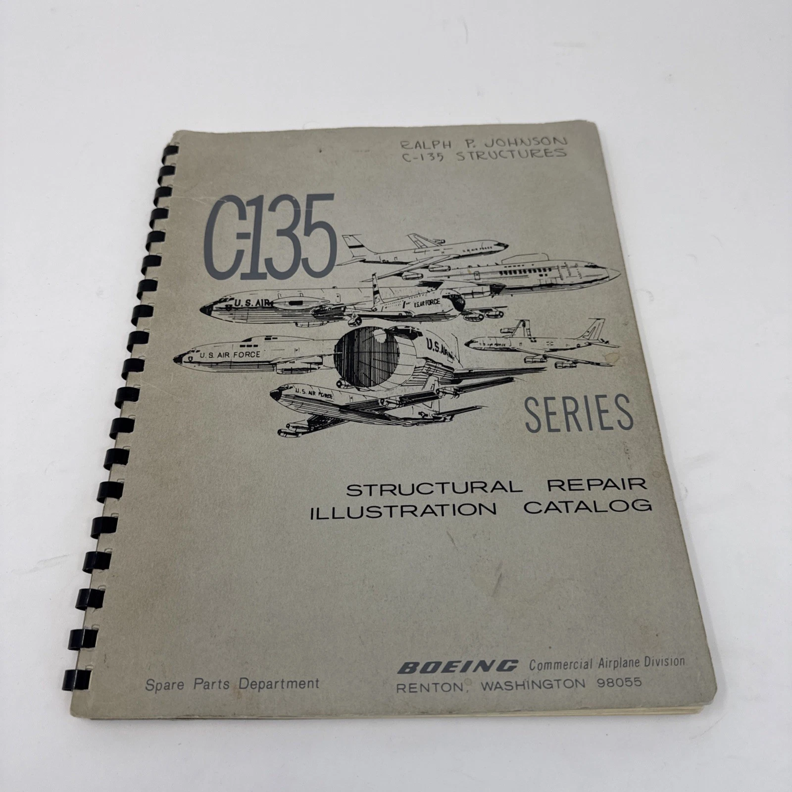 Boeing C-135 Series Structural Repair Illustration Catalog cover with line-drawing illustrations of multiple C-135 airframe variants in formation flight, spiral-binding visible at left edge, with handwritten provenance 'Ralph F. Johnson C-135 Structures' in the upper right corner