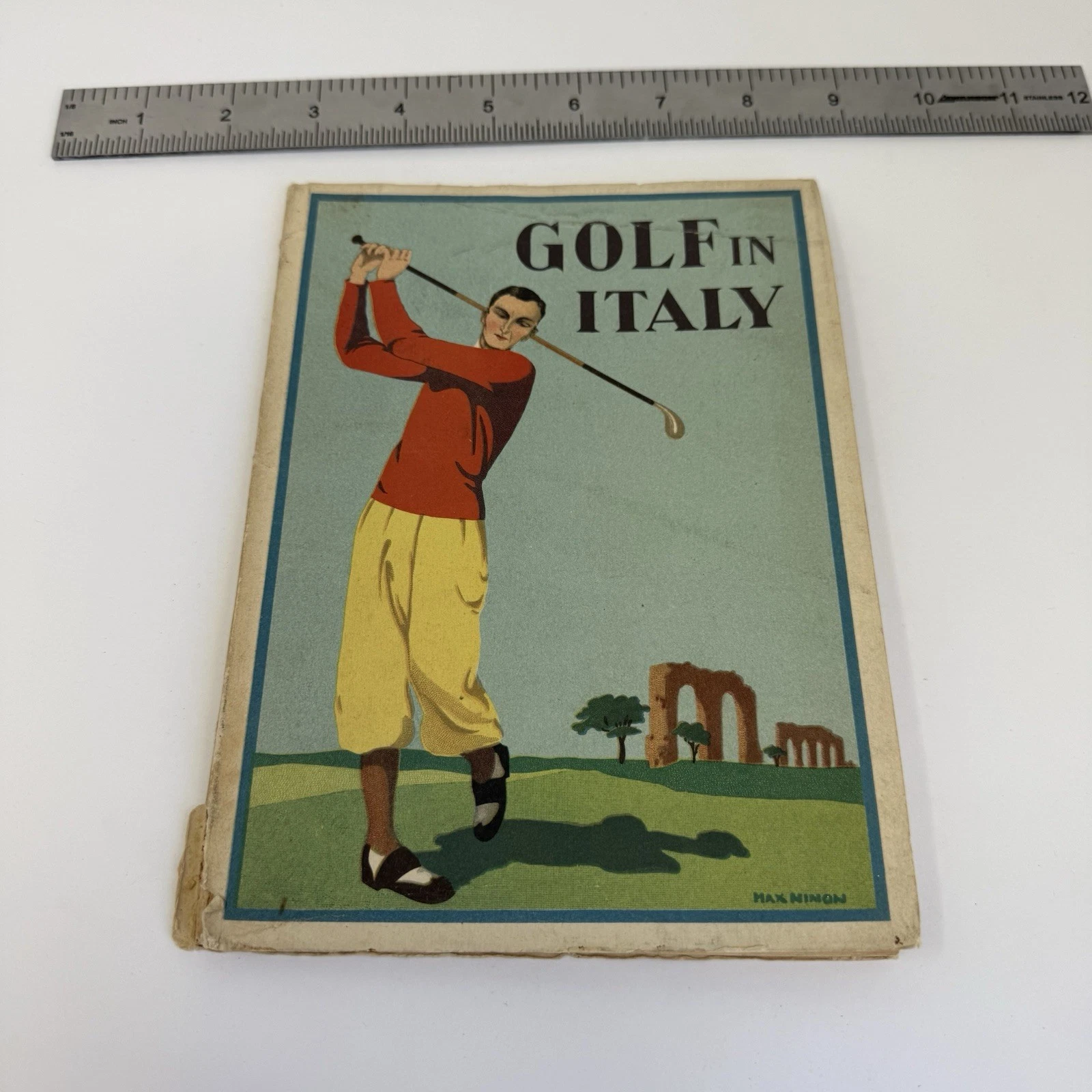 The Art Deco cover of Golf in Italy, 1930s, Italian state tourist department brochure with stylized golfer in red and yellow against classical ruins