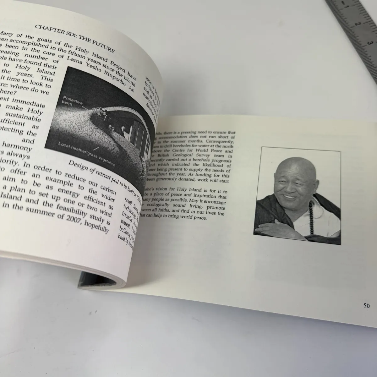 Page from the Future chapter with a small black-and-white portrait of Yeshe Losal Rinpoche smiling, wearing dark robes and a mala, plus a diagram of the planned retreat-pod design with protective berm and local heather and grass vegetation surrounding the structure, with text describing fifteen-year care of the island, plans for boreholes and wind energy