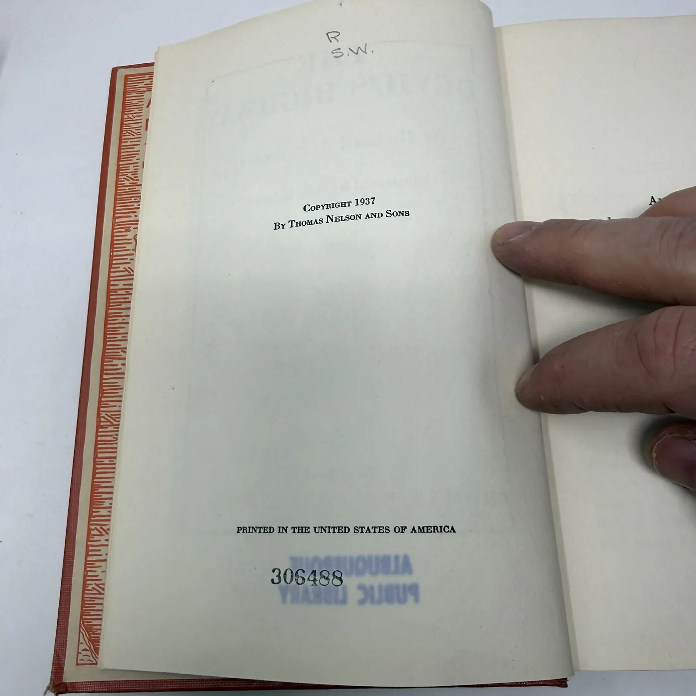 The copyright page of The Devil's Highway. Centered text reads: 'COPYRIGHT 1937 / By Thomas Nelson and Sons'. Three blank lines below, in small caps: 'PRINTED IN THE UNITED STATES OF AMERICA'. At the foot of the page, upside down, a purple ALBUQUERQUE PUBLIC LIBRARY rectangular stamp and an accession-number marking '306488' written in pencil.