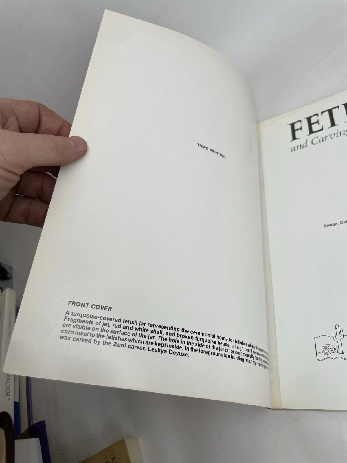 The page facing the title page noting 'THIRD PRINTING' and a description of the front cover crucified turquoise-covered fetish jar