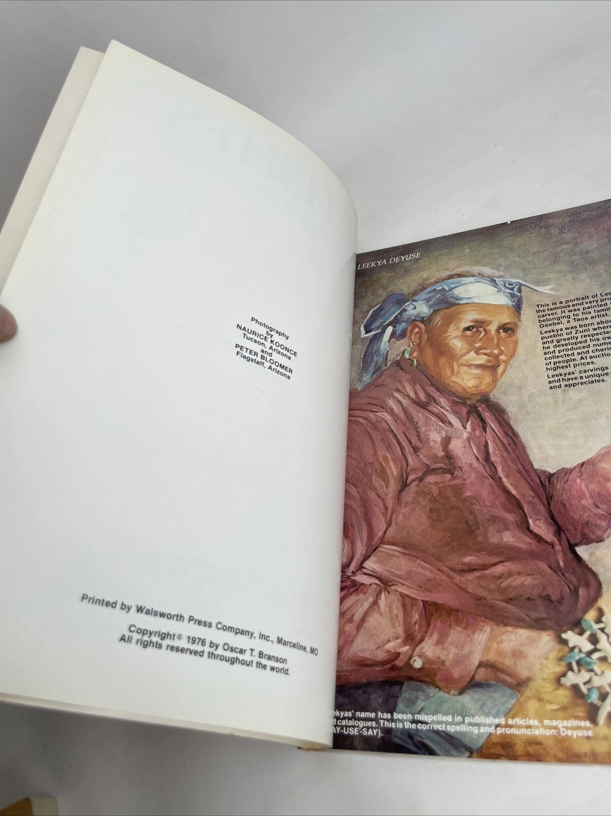 An interior spread showing a painted illustration of an older Tewa carver, possibly Crucita, with text about Native American carvers