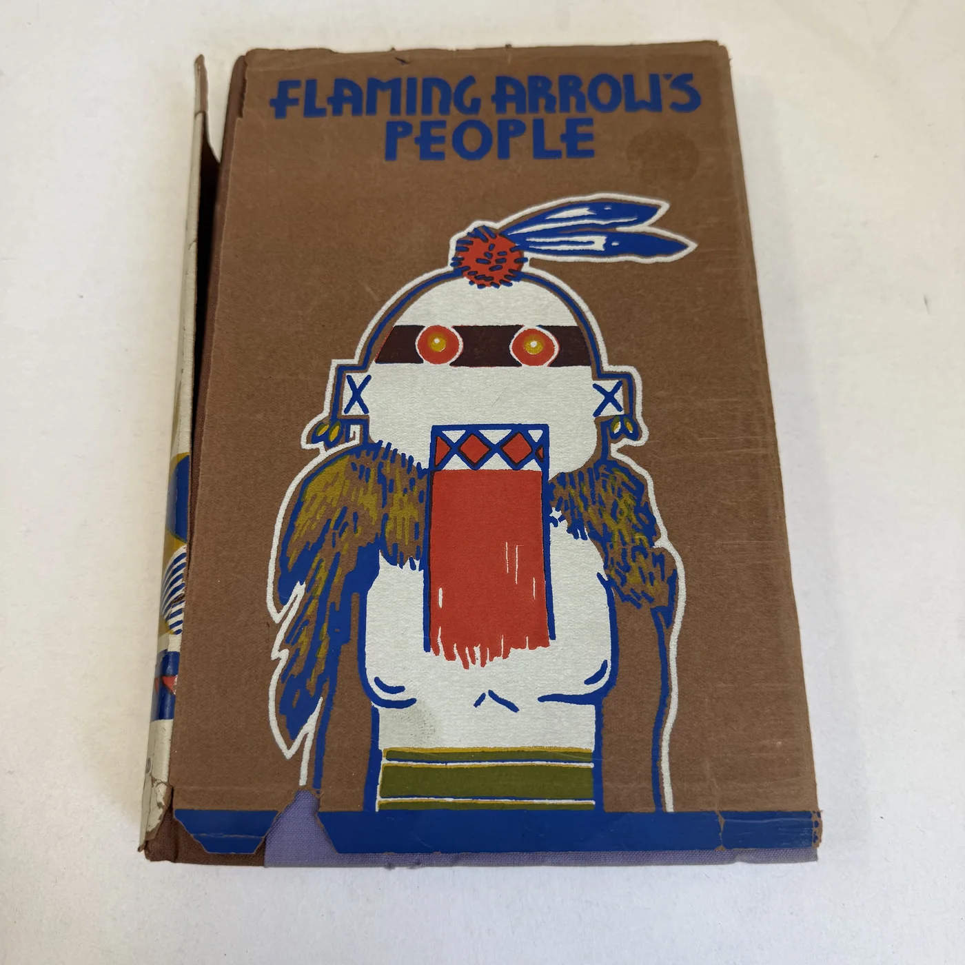 Pictorial 1932 dust jacket of Flaming Arrow's People by An Acoma Indian, James Paytiamo, with the author's own dancer design, photographed at New Mexico Literacy Project