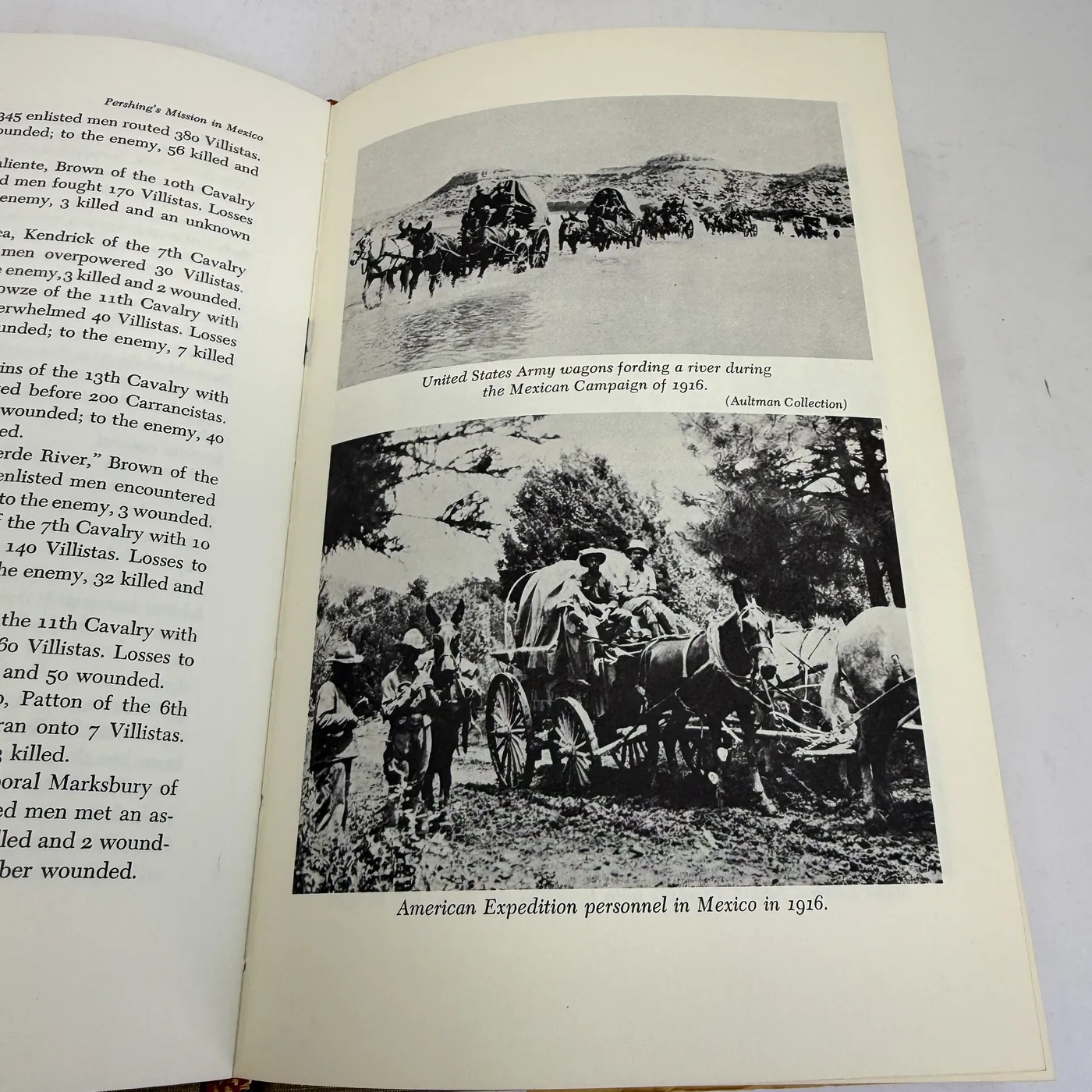 An interior page of Pershing's Mission in Mexico showing two historic black-and-white photographs from the Aultman Collection: top image of United States Army wagons fording a river during the Mexican Campaign of 1916 with a line of mule-drawn wagons in shallow water against a desert mesa backdrop; bottom image of American Expedition personnel in Mexico in 1916 with covered wagons, mules, soldiers in campaign hats.