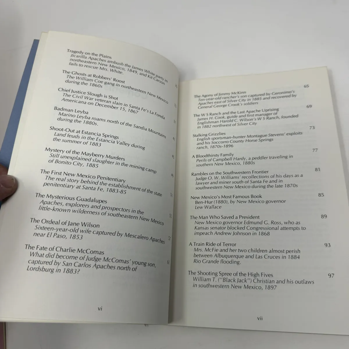 Two-page table of contents showing essay titles including Tragedy on the Plains, The Ghosts at Robbers Roost, Chief Justice Slough is Shot, Badman Leyba, Shoot-out at Estancia Springs, Mystery of the Mayberry Murders, The First New Mexico Penitentiary, The Mysterious Guadalupes, The Ordeal of Jane Wilson, The Fate of Charlie McComas, A Bloodthirsty Family, Stalking Grizzlies, New Mexico's Most Famous Book, The Man Who Saved a President, A Train Ride of Terror, The Shooting Spree of the High Fives