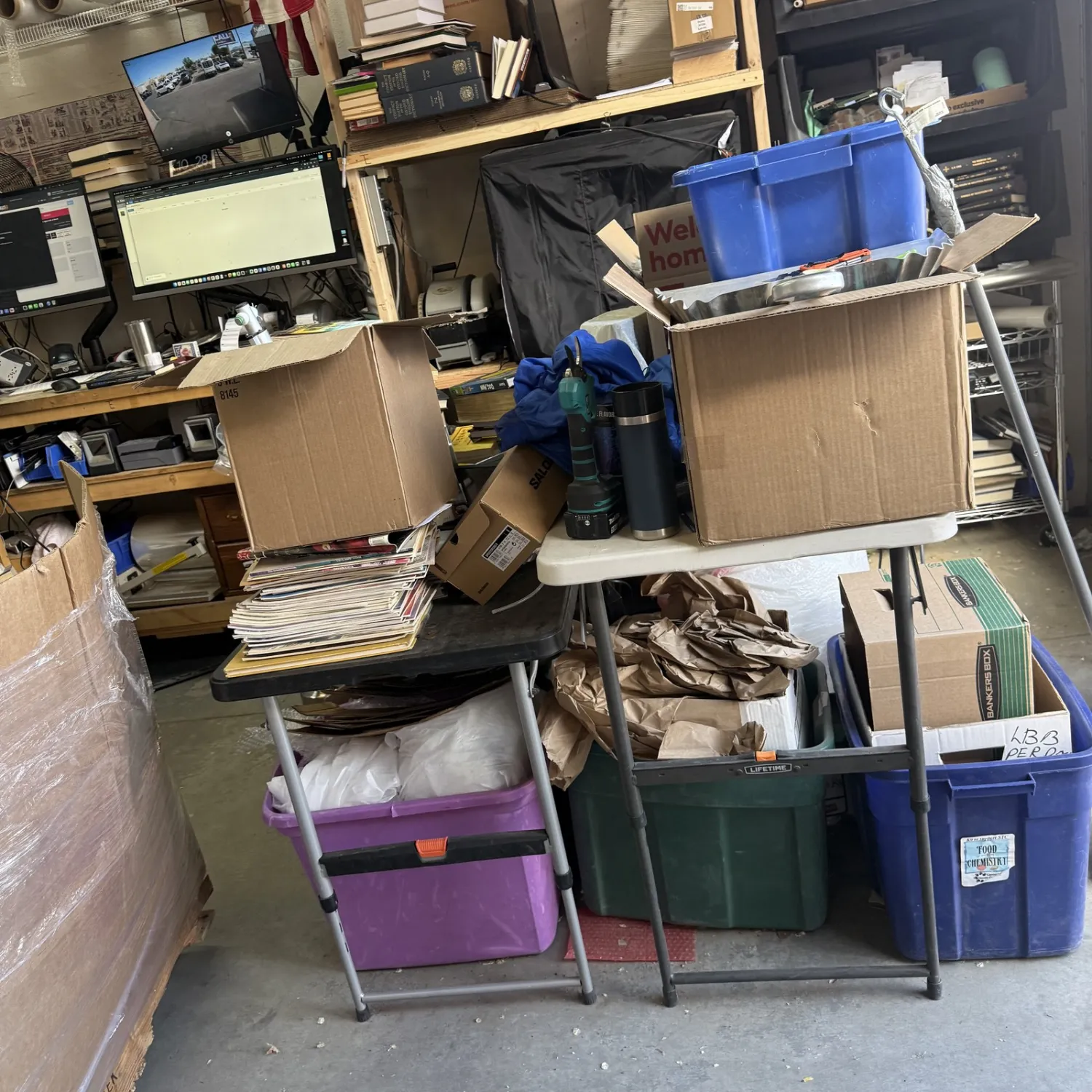 A view inside the NMLP warehouse with stacked boxes of donated books visible on shelves and on the floor.