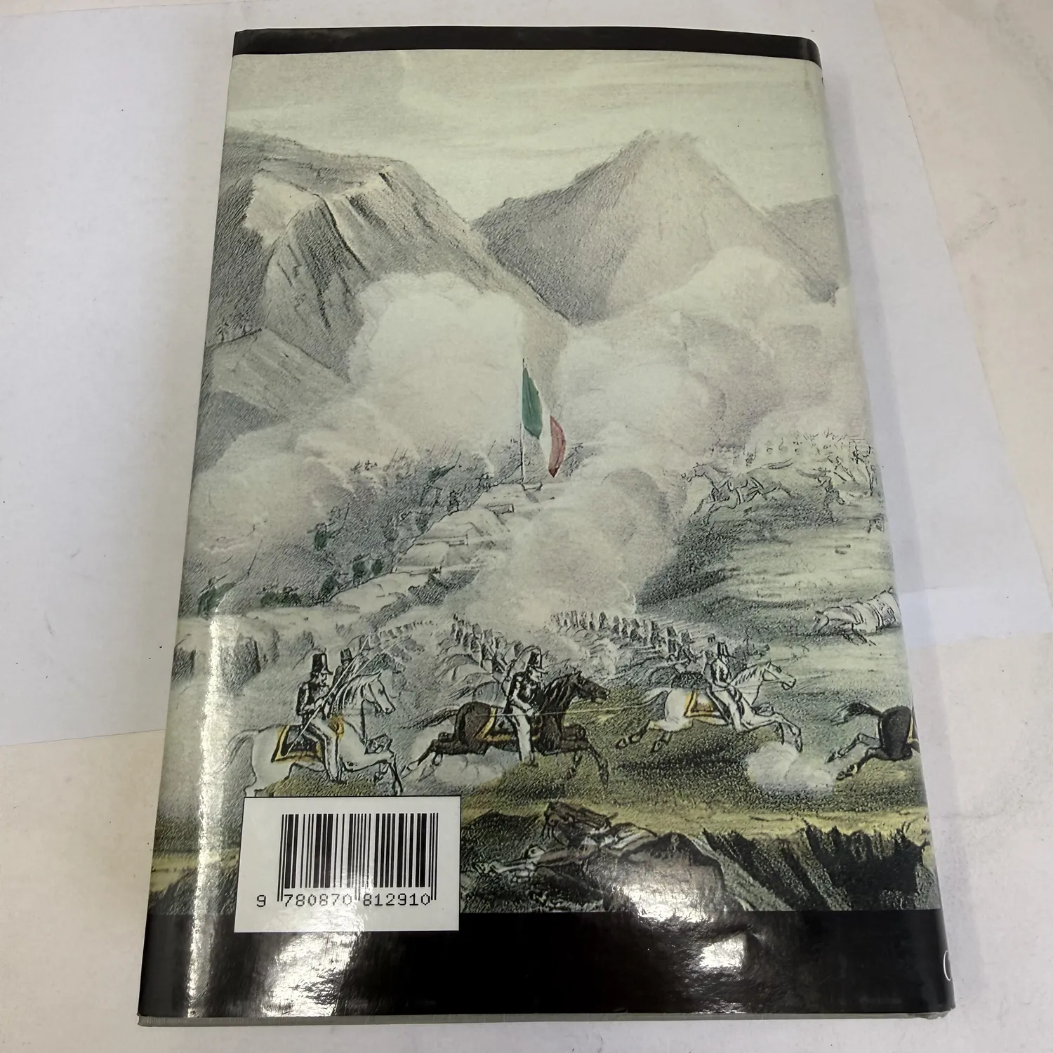Back cover of Brothers on the Santa Fe and Chihuahua Trails dust jacket showing continuation of Mexican War battle scene engraving with mounted cavalry charging, infantry formations, Mexican flag visible above defensive positions, cannon smoke and mountain landscape, ISBN barcode 9780870812910 at bottom left, University Press of Colorado 1993, photographed at New Mexico Literacy Project