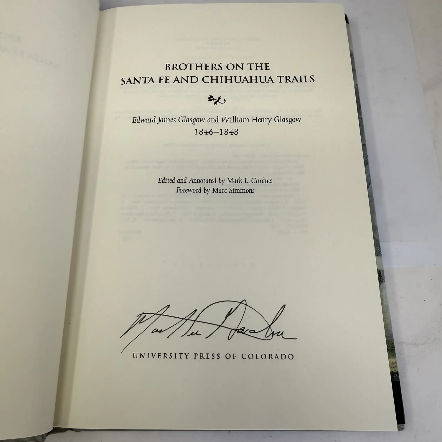 Title page of Brothers on the Santa Fe and Chihuahua Trails showing full title, Edward James Glasgow and William Henry Glasgow 1846-1848, Edited and Annotated by Mark L. Gardner, Foreword by Marc Simmons, University Press of Colorado, with Mark L. Gardner signature in black ink on the page, signed first edition, photographed at New Mexico Literacy Project