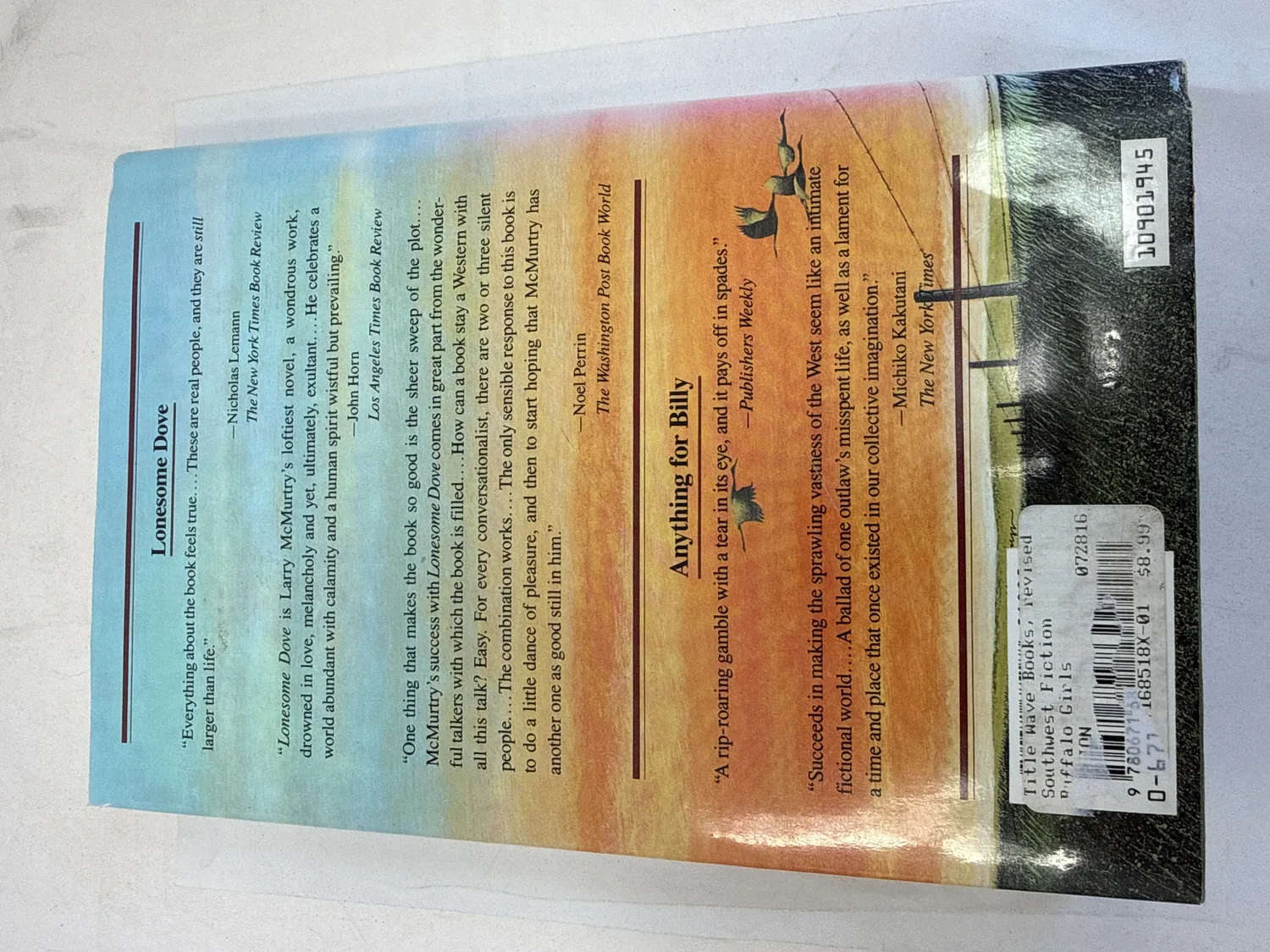 Back cover of Buffalo Girls first edition showing review quotes for Lonesome Dove and Anything for Billy from Publishers Weekly, New York Times, and Washington Post. Photographed at the New Mexico Literacy Project sorting desk in Albuquerque.