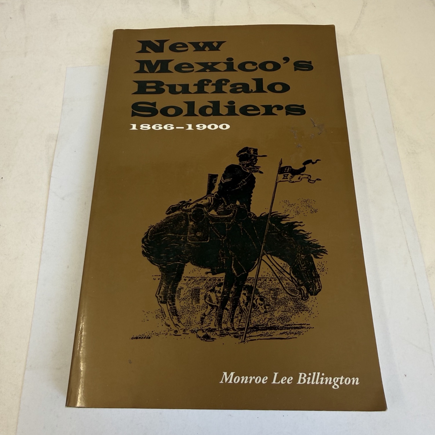 Front cover of New Mexico's Buffalo Soldiers, 1866-1900 by Monroe Lee Billington — brown and olive cover with pen-and-ink illustration of a mounted Buffalo Soldier carrying a regimental guidon, University Press of Colorado, ISBN 0-87081-346-3