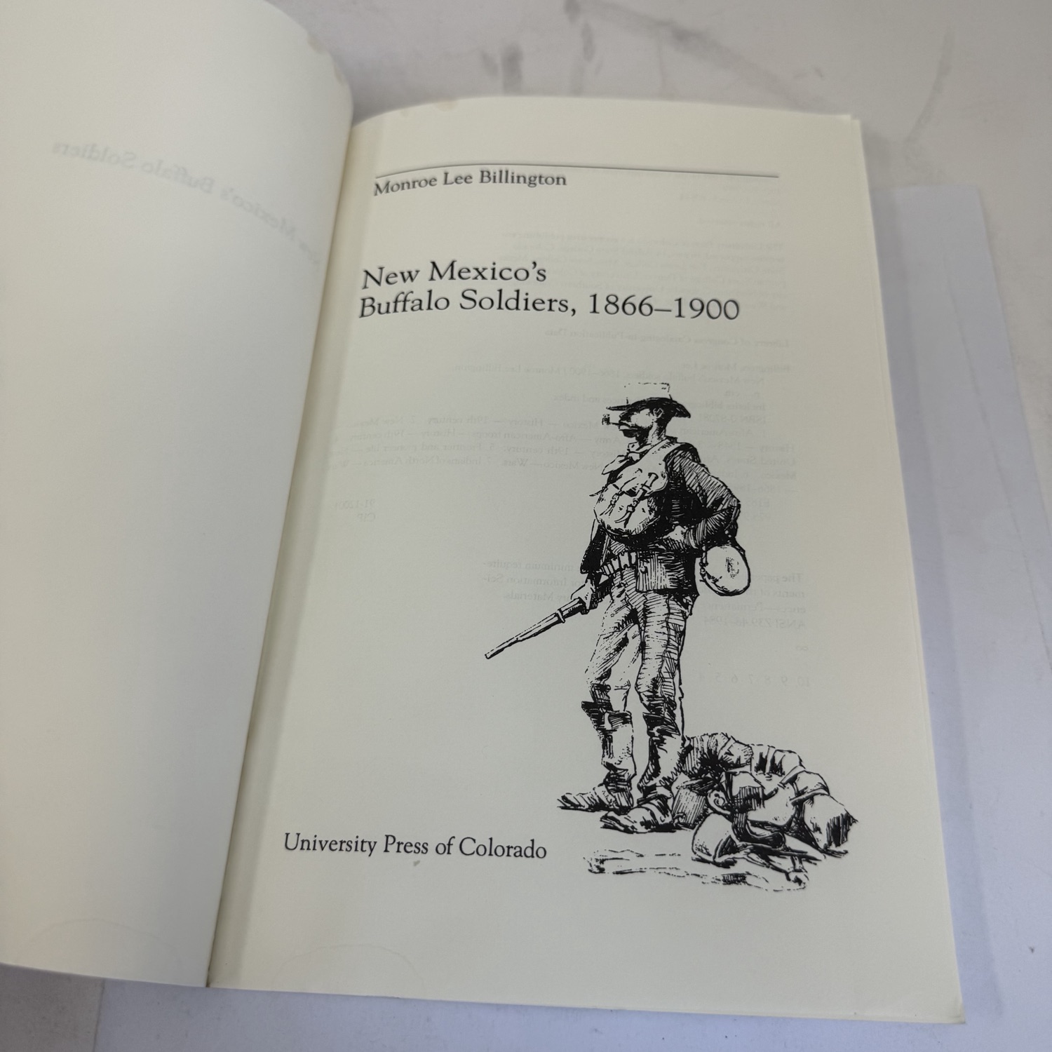 Title page of New Mexico's Buffalo Soldiers, 1866-1900 by Monroe Lee Billington — pen-and-ink illustration of a standing soldier with fallen figure, University Press of Colorado imprint