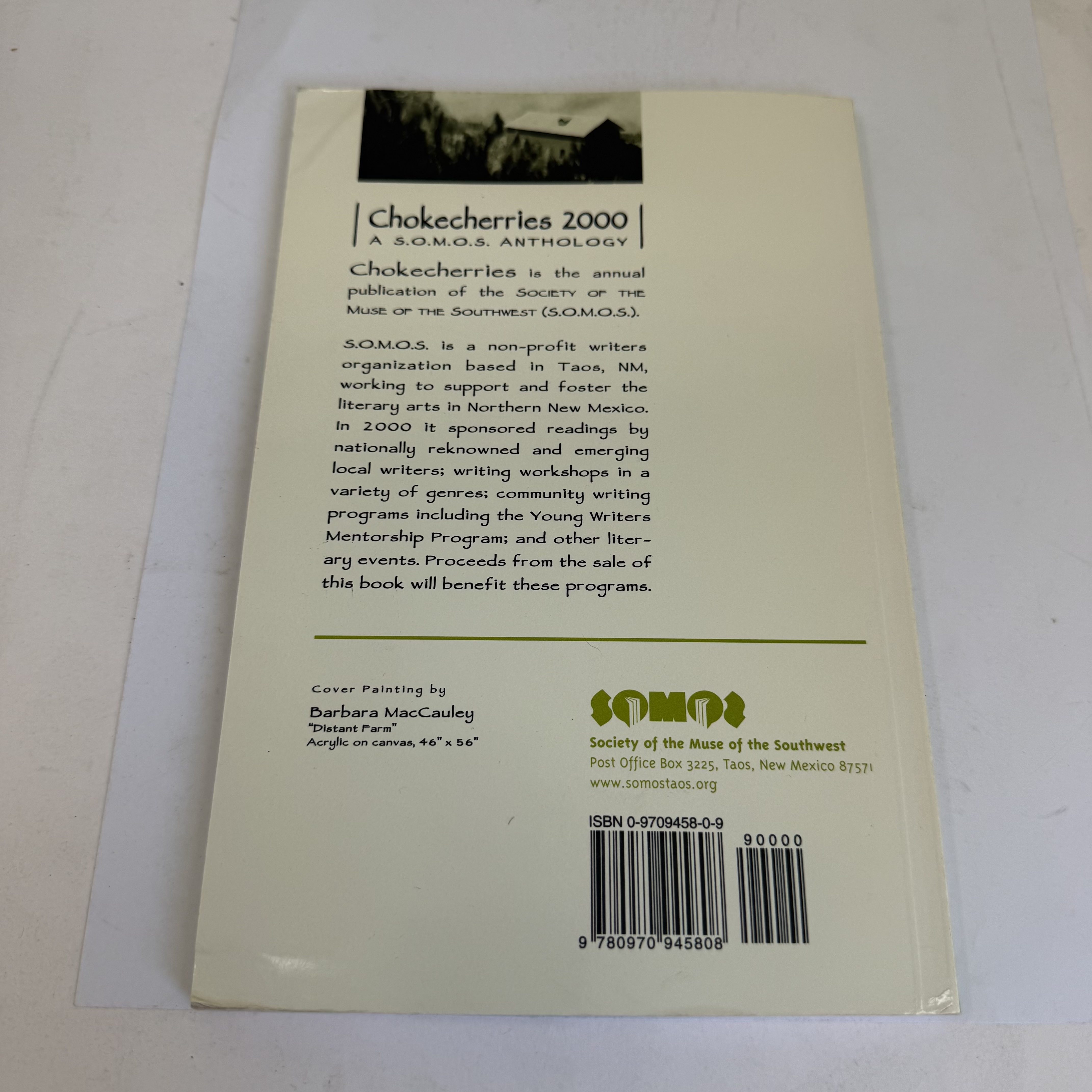 Back cover of Chokecherries 2000: A S.O.M.O.S. Anthology showing the S.O.M.O.S. mission statement, PO Box 3225 Taos New Mexico 87571 address, cover painting credit to Barbara MacCauley for Distant Farm, and ISBN 0-9709458-0-9 barcode