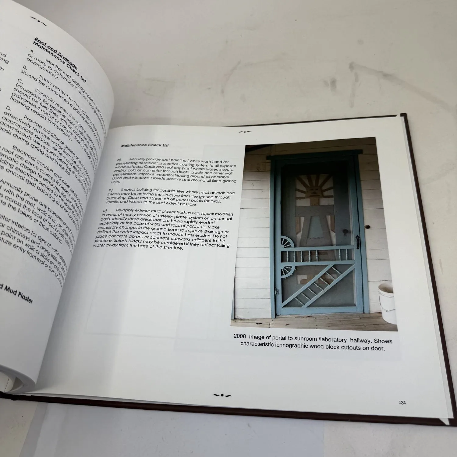 Interior page from Couse-Sharp Historic Building Assessment showing 2008 photograph of portal and sunroom doorway with ichnographic wood block cutouts and maintenance checklist for historic preservation — photographed by Josh Eldred at NMLP workspace