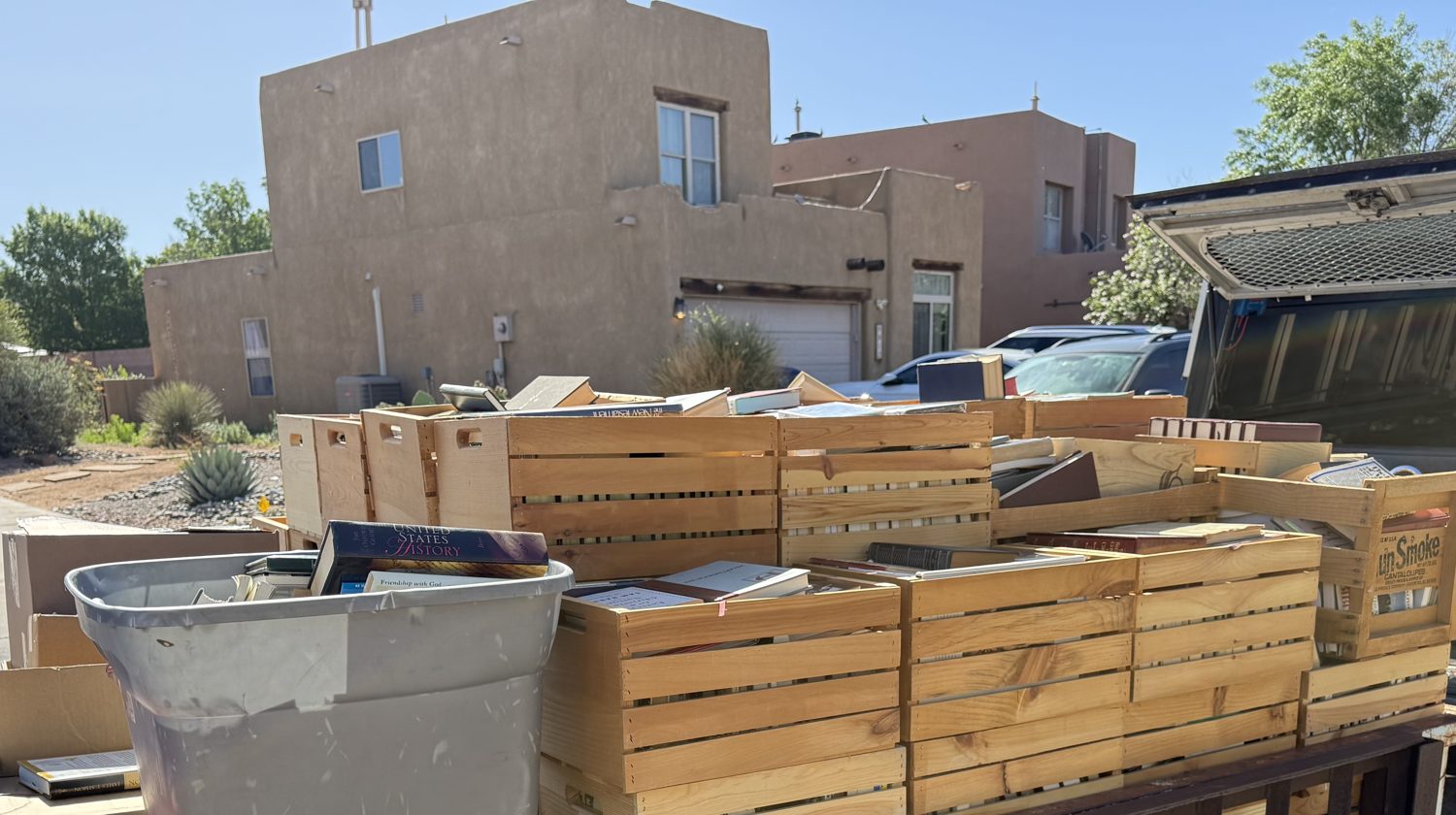 Wooden crates full of donated books loaded on a trailer at an Albuquerque estate book pickup