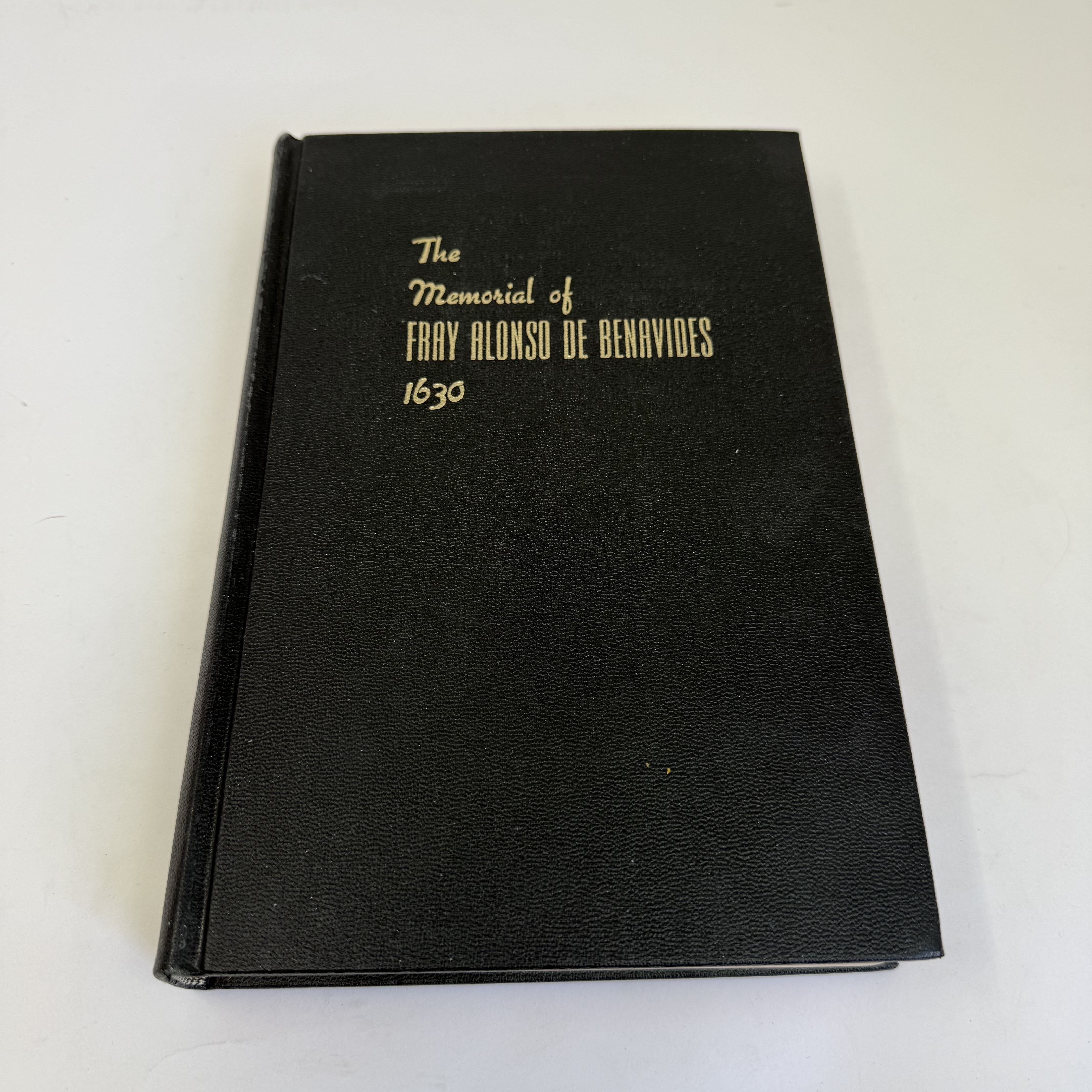 A black hardcover book with gold script reading 'The Memorial of Fray Alonso de Benavides 1630', a foundational document of early-colonial New Mexico history, donated to NMLP after being rejected for sorting at an Albuquerque-area library.