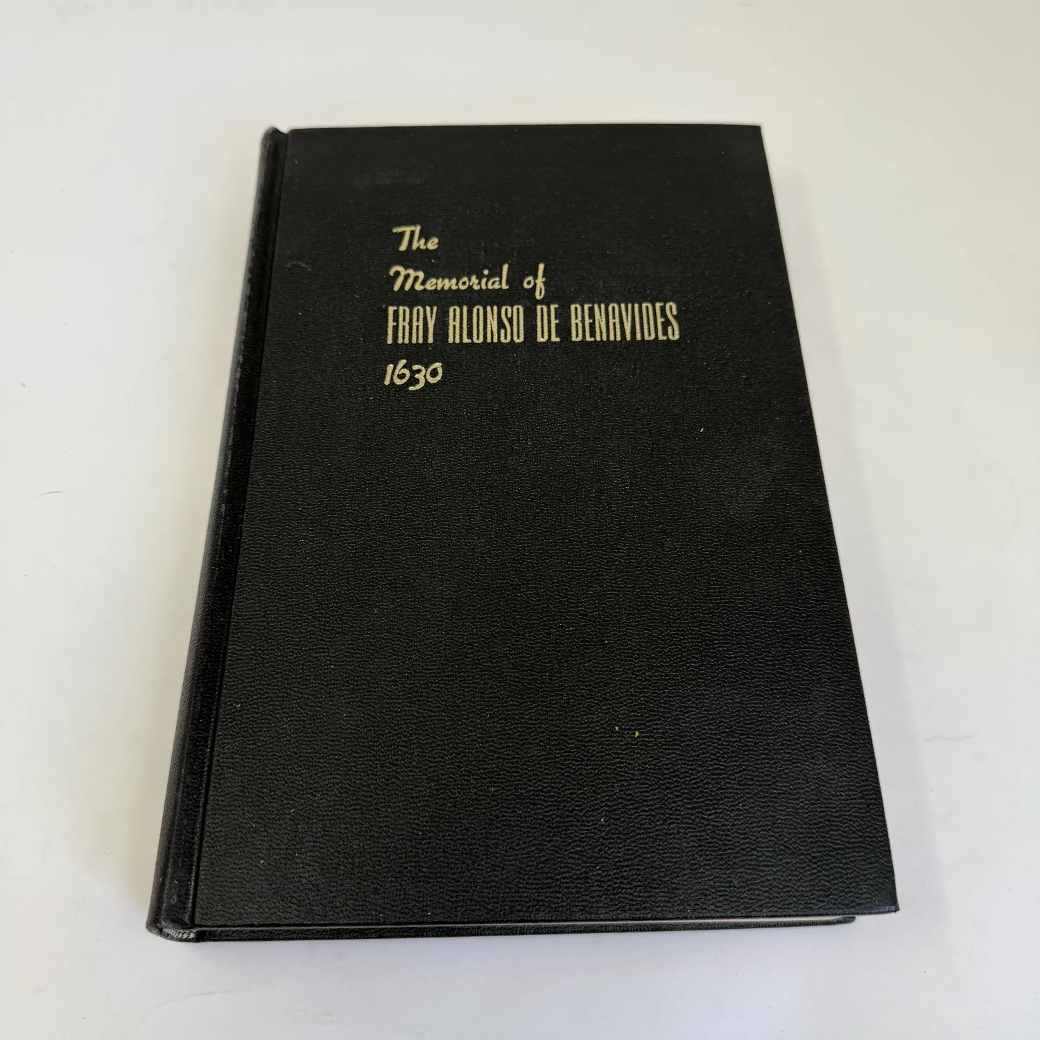 A black hardcover book with gold script reading 'The Memorial of Fray Alonso de Benavides 1630', a foundational document of early-colonial New Mexico history, donated to NMLP after being rejected for sorting at an Albuquerque-area library.