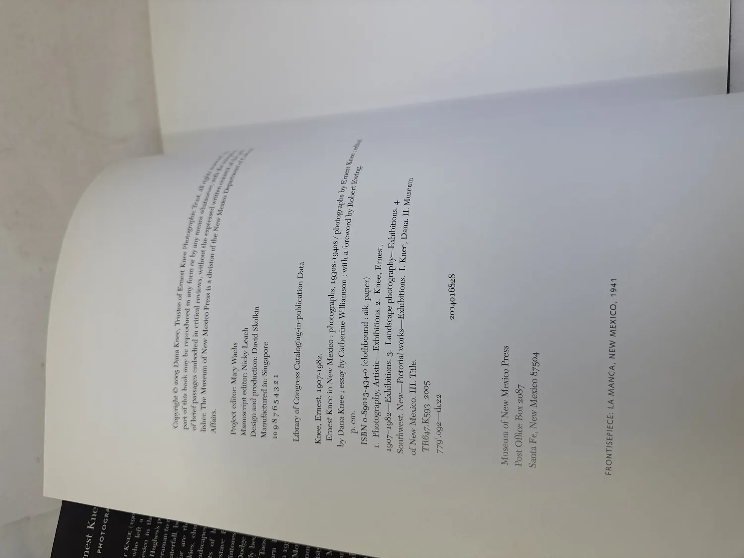 Copyright page of Ernest Knee in New Mexico showing ISBN 0-89013-434-0 clothbound, Library of Congress cataloging data, copyright 2005 Dana Knee Trustee, project editor Mary Wachs, design David Skolkin, number line 10 9 8 7 6 5 4 3 2 1 confirming first printing, Museum of New Mexico Press Santa Fe 87504. Photographed at the New Mexico Literacy Project sorting desk in Albuquerque.