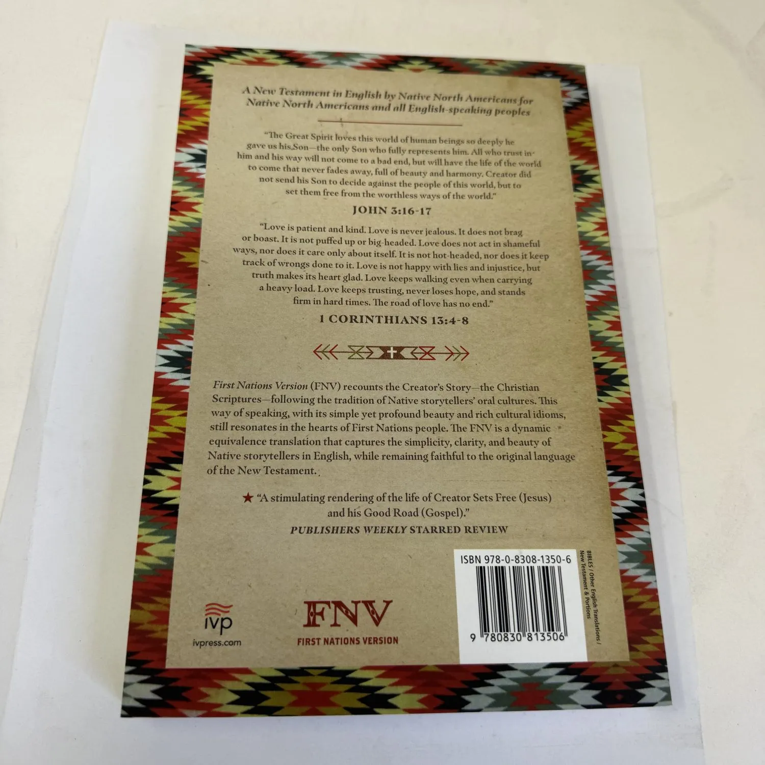 Back cover of First Nations Version New Testament showing John 3:16-17 and 1 Corinthians 13:4-8 in First Nations translation with Publishers Weekly starred review blurb