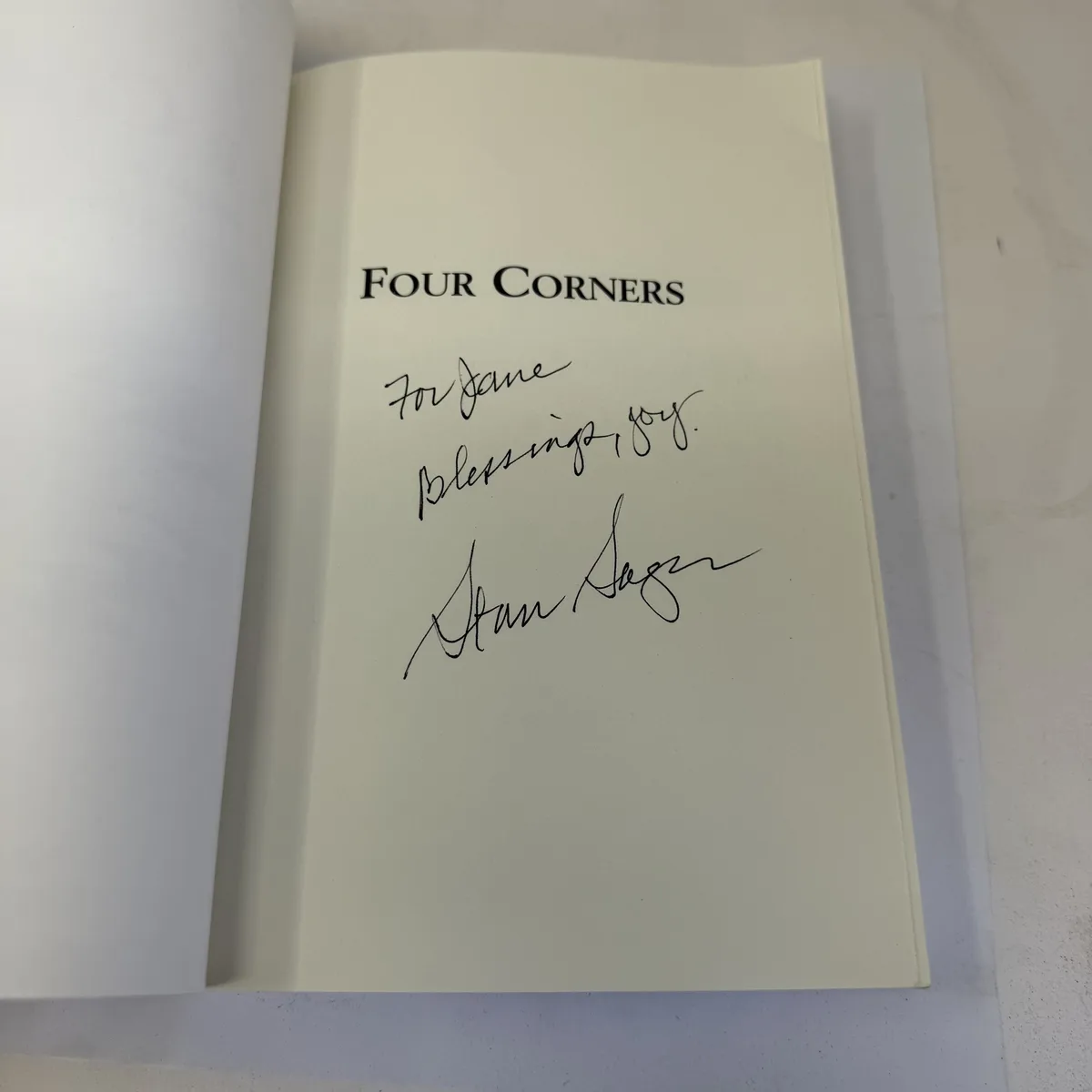 Author inscription in Four Corners Where the Holy Spirit Touches Navajo Hearts by Stan Sager reading For Jane Blessings joy Stan Sager in blue ink on half-title page, Providence House Publishers 2007, signed copy found in Albuquerque estate donation, photographed at the New Mexico Literacy Project sorting desk