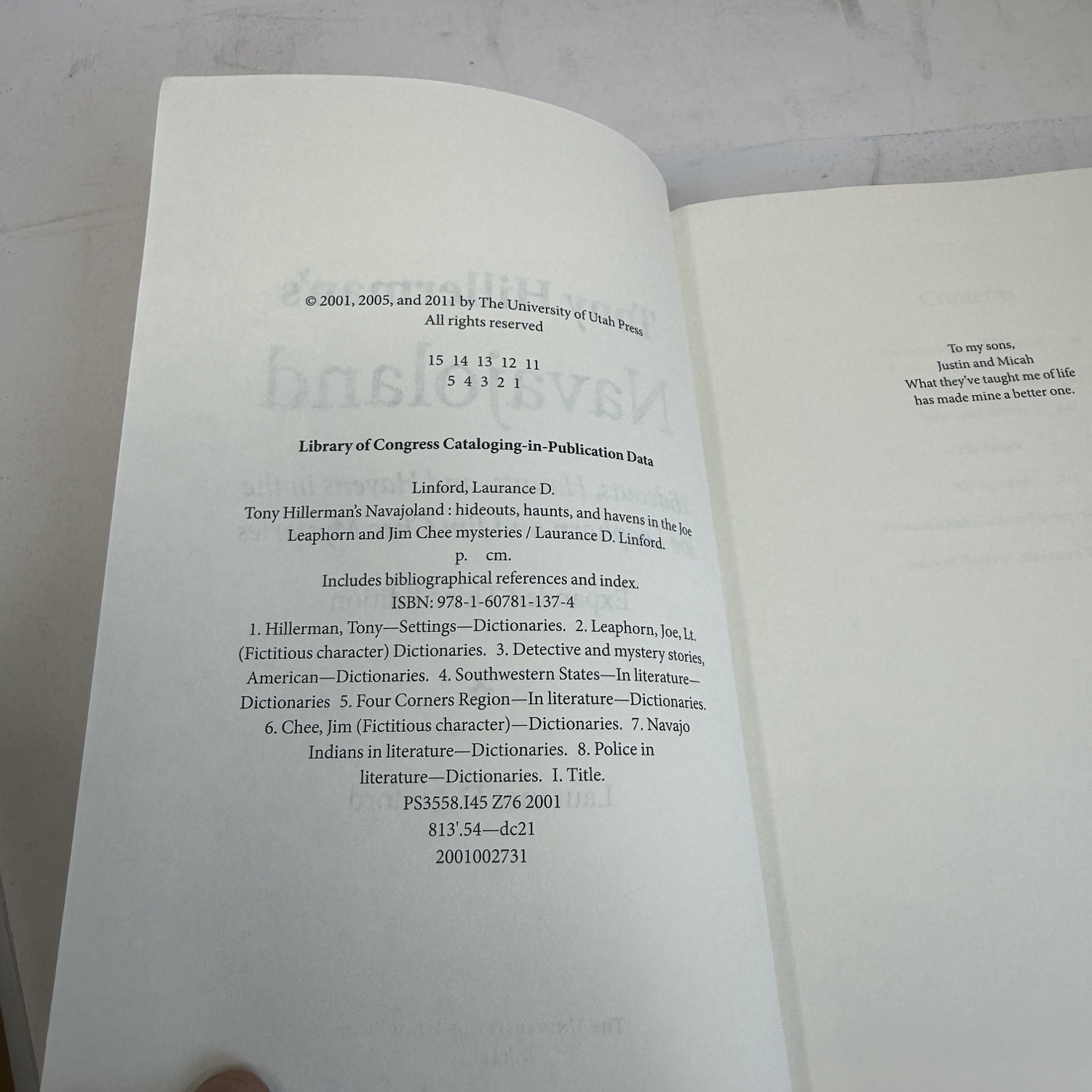 Copyright page and dedication of Tony Hillerman's Navajoland by Laurance D. Linford showing copyright years 2001, 2005, and 2011, number line 15 14 13 12 11 / 5 4 3 2 1, ISBN 978-1-60781-137-4, Library of Congress data PS3558.145 Z76 2001, and dedication to sons Justin and Micah