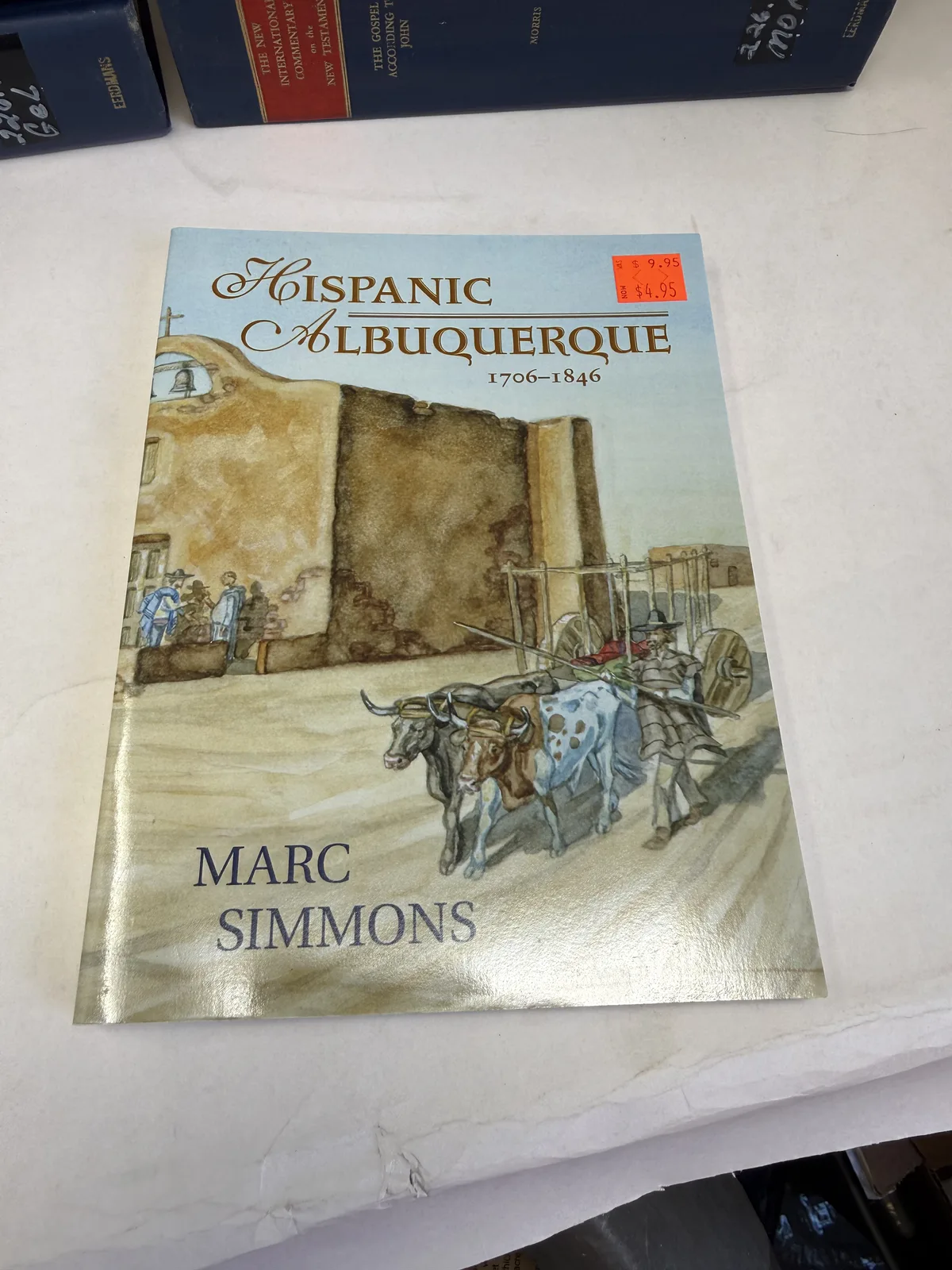 Cover of Hispanic Albuquerque 1706 to 1846 by Marc Simmons with a painting of a mounted rider in colonial Albuquerque, photographed at New Mexico Literacy Project