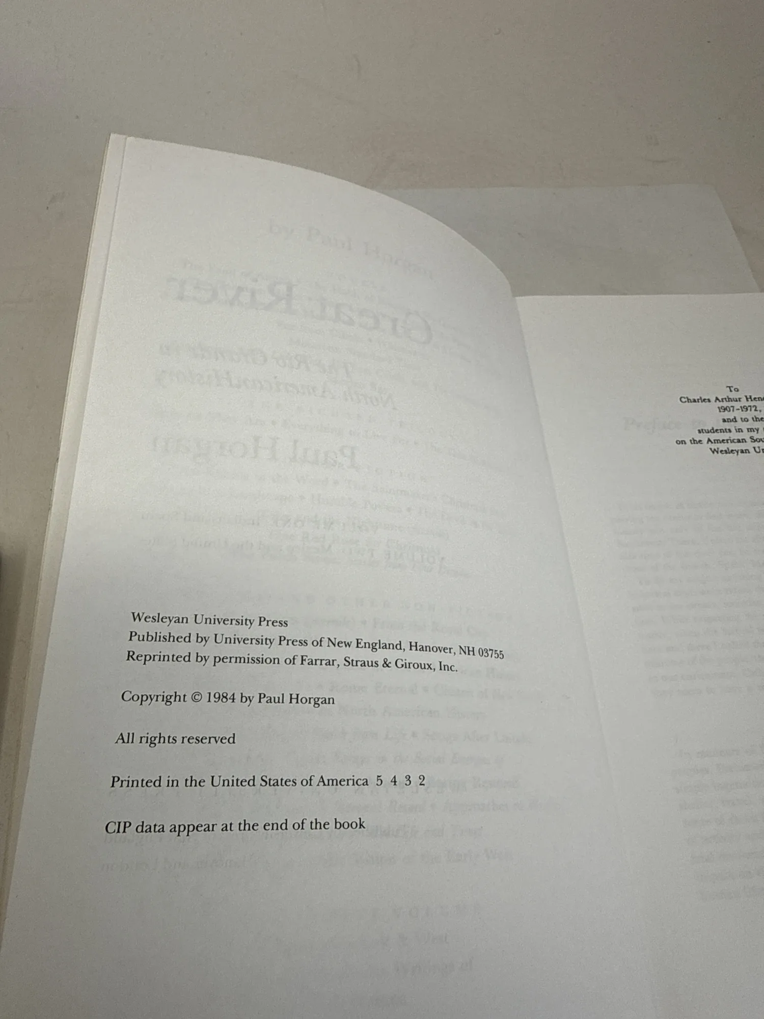 Copyright page of Great River by Paul Horgan showing Wesleyan University Press, Published by University Press of New England Hanover NH 03755, Reprinted by permission of Farrar Straus and Giroux Inc, Copyright 1984 by Paul Horgan, number line 5 4 3 2, and dedication to Charles Arthur Horgan 1907-1971. Photographed at the New Mexico Literacy Project sorting desk in Albuquerque.