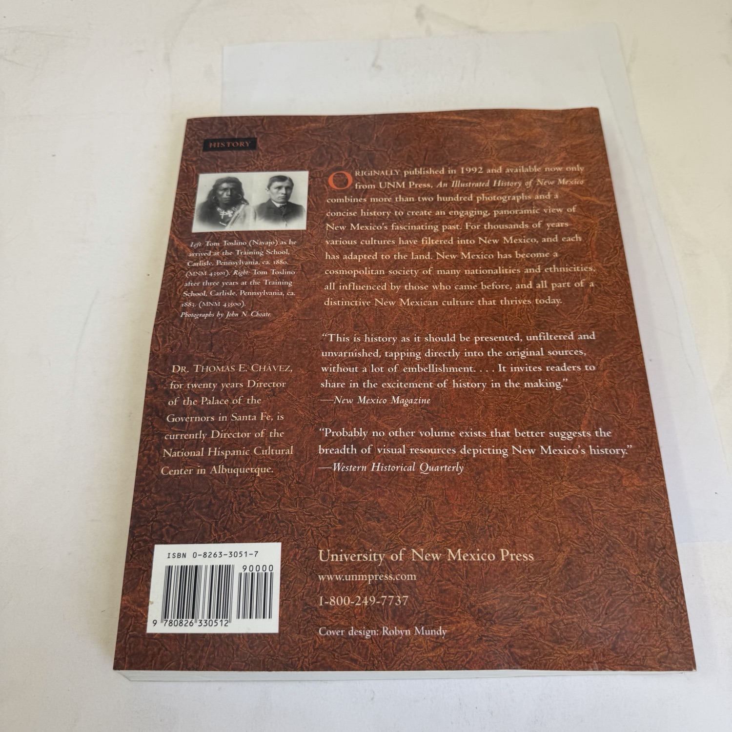 Back cover of An Illustrated History of New Mexico showing author bio for Thomas E. Chávez — Director of the Palace of the Governors and National Hispanic Cultural Center — with praise from New Mexico Magazine and Western Historical Quarterly, Carlisle Indian School photo captions identifying Tony Todaro (Navajo), ISBN barcode