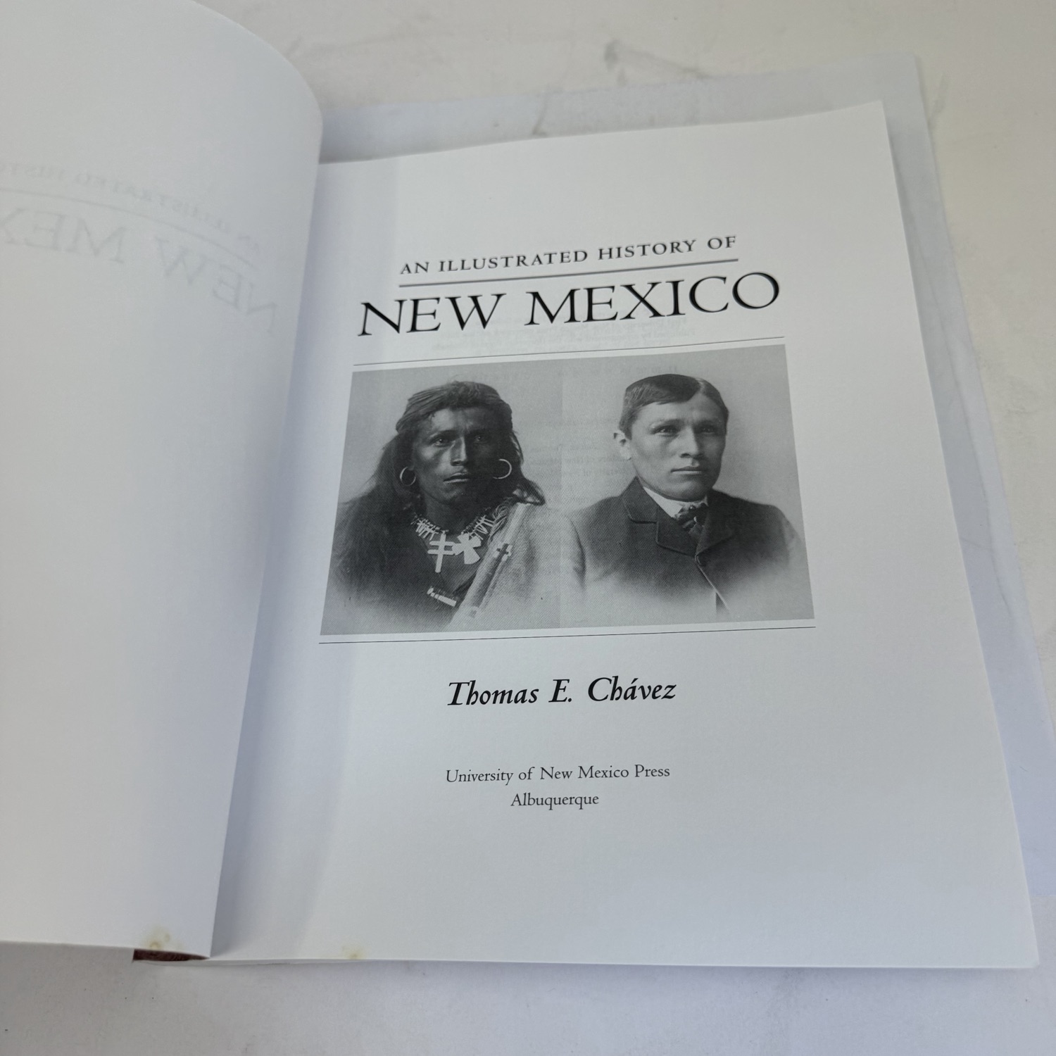 Title page of An Illustrated History of New Mexico by Thomas E. Chávez showing the same two Carlisle Indian School portraits, published by University of New Mexico Press Albuquerque