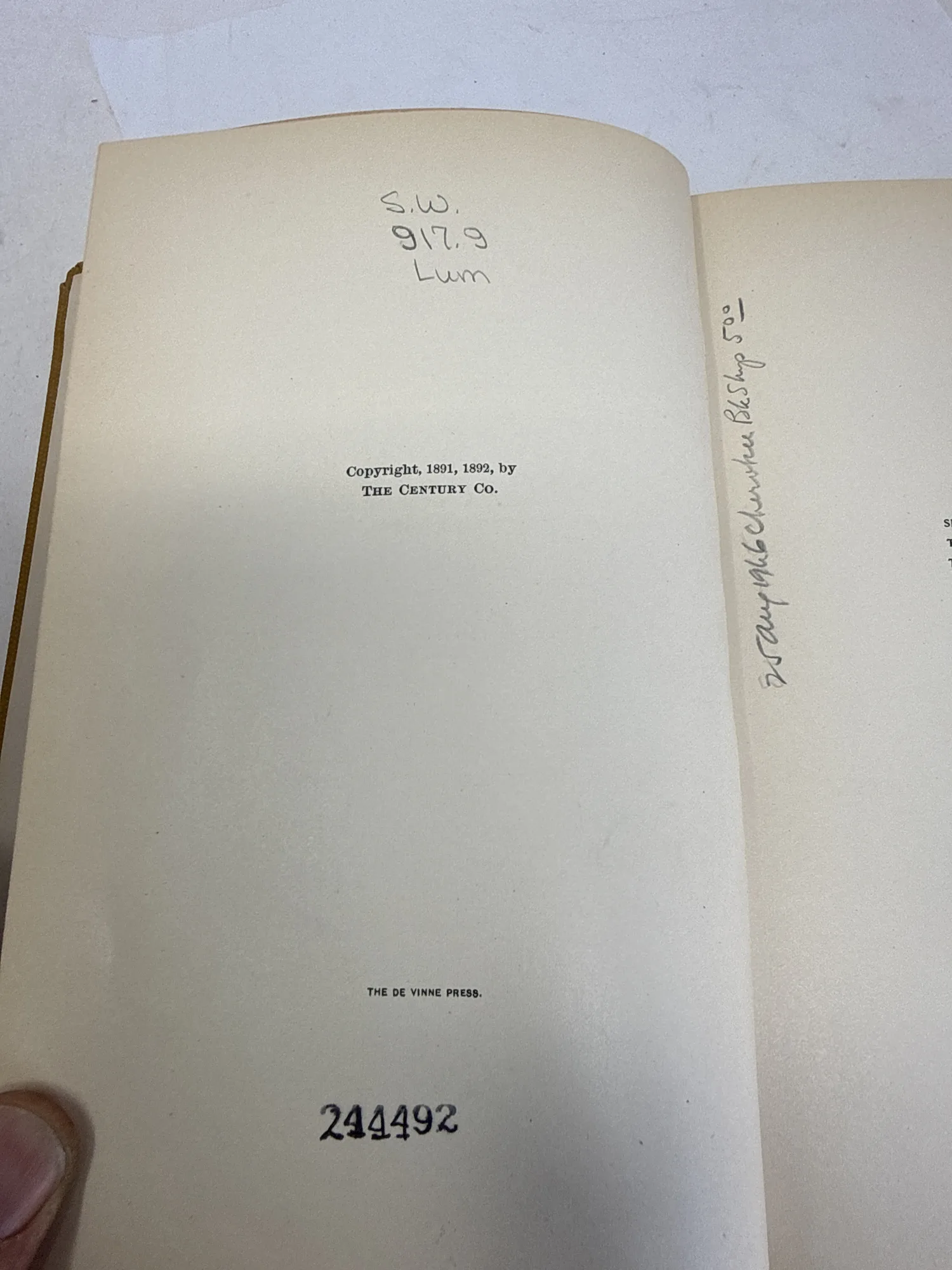 Copyright page of Some Strange Corners of Our Country showing Copyright 1891 1892 by The Century Co and The De Vinne Press printer credit, with Albuquerque Public Library accession number 244492 and Dewey call number. Photographed at the New Mexico Literacy Project sorting desk in Albuquerque.