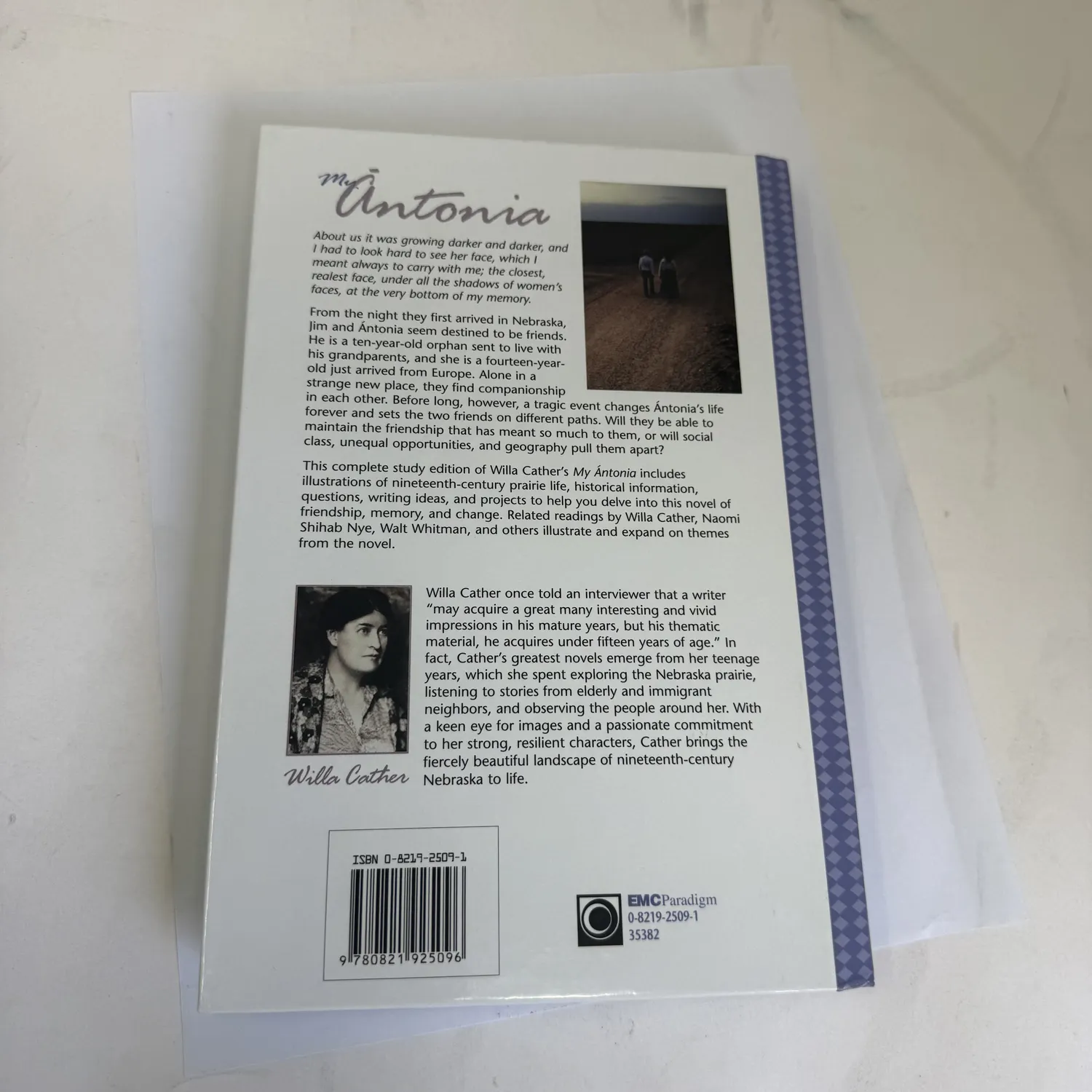 Back cover of My Ántonia by Willa Cather EMC Masterpiece Series Access Edition showing series branding and publisher information, photographed at the New Mexico Literacy Project sorting desk in Albuquerque