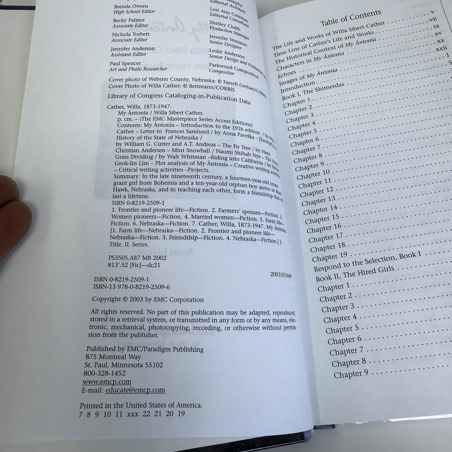 Copyright page and table of contents of My Ántonia by Willa Cather, EMC Masterpiece Series Access Edition showing copyright 2003 by EMC Corporation, editorial apparatus and chapter structure of the study edition, photographed at the New Mexico Literacy Project sorting desk