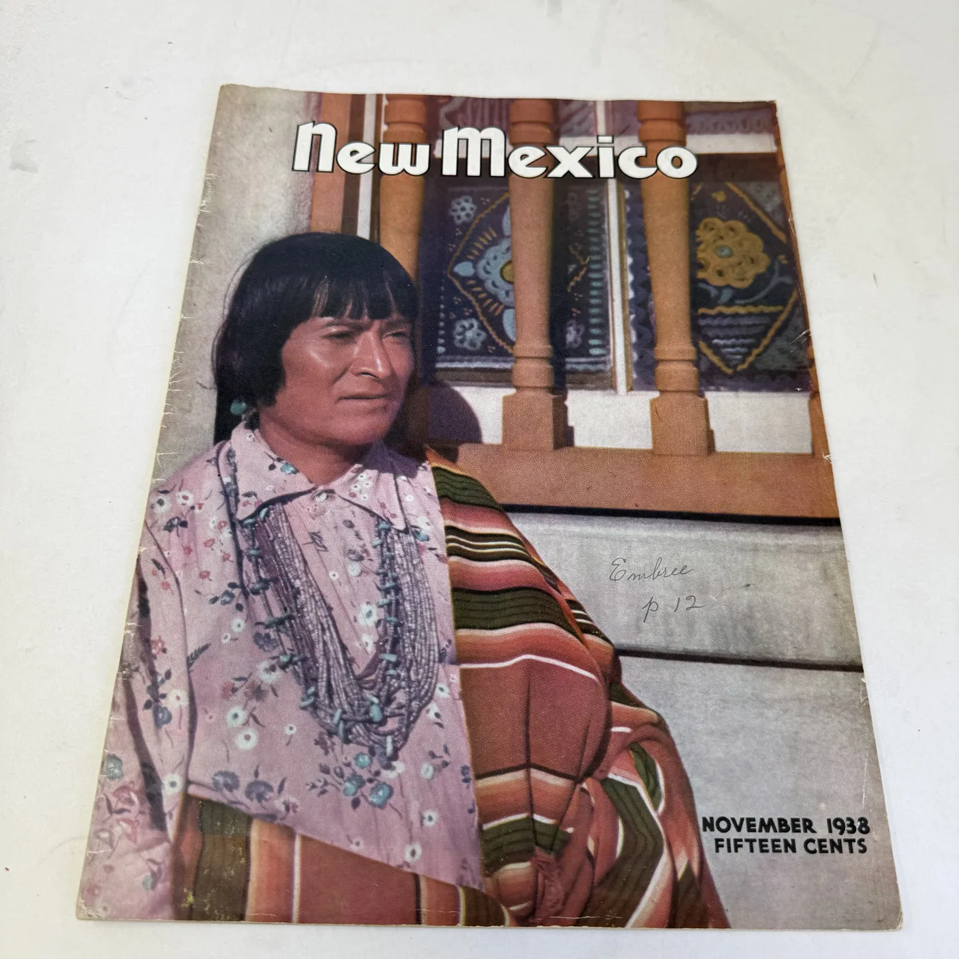 New Mexico Magazine November 1938 cover: hand-tinted portrait of a Pueblo man in a striped blanket, fifteen cents — photographed at New Mexico Literacy Project