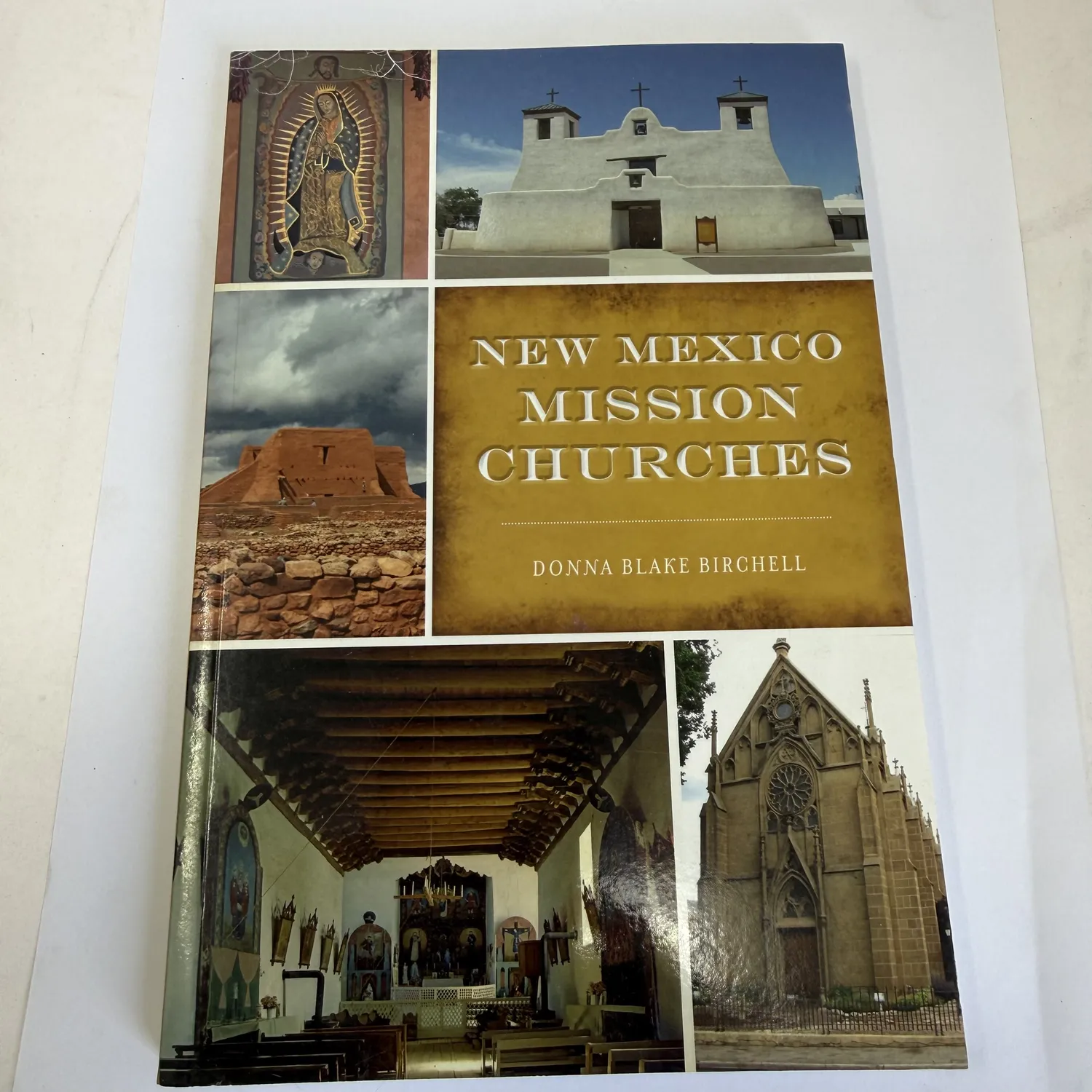 Front cover of New Mexico Mission Churches by Donna Blake Birchell — photo collage showing Our Lady of Guadalupe image, white adobe Pueblo mission church, Pecos Pueblo ruins, Loretto Chapel, and mission interior with vigas and carved reredos, published by The History Press
