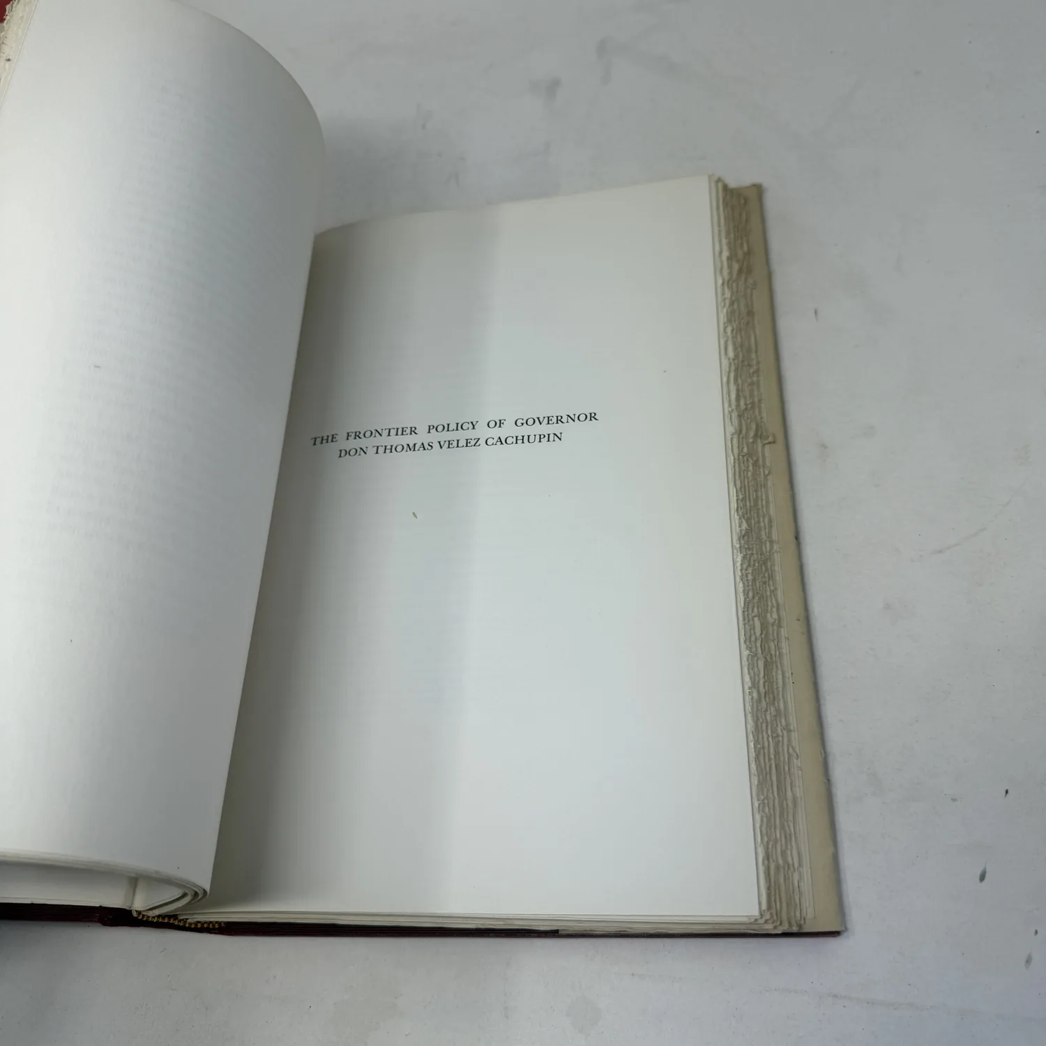 Part-title for The Frontier Policy of Governor Don Thomas Velez Cachupin with the untrimmed fore-edge of the 1940 first edition, photographed at New Mexico Literacy Project