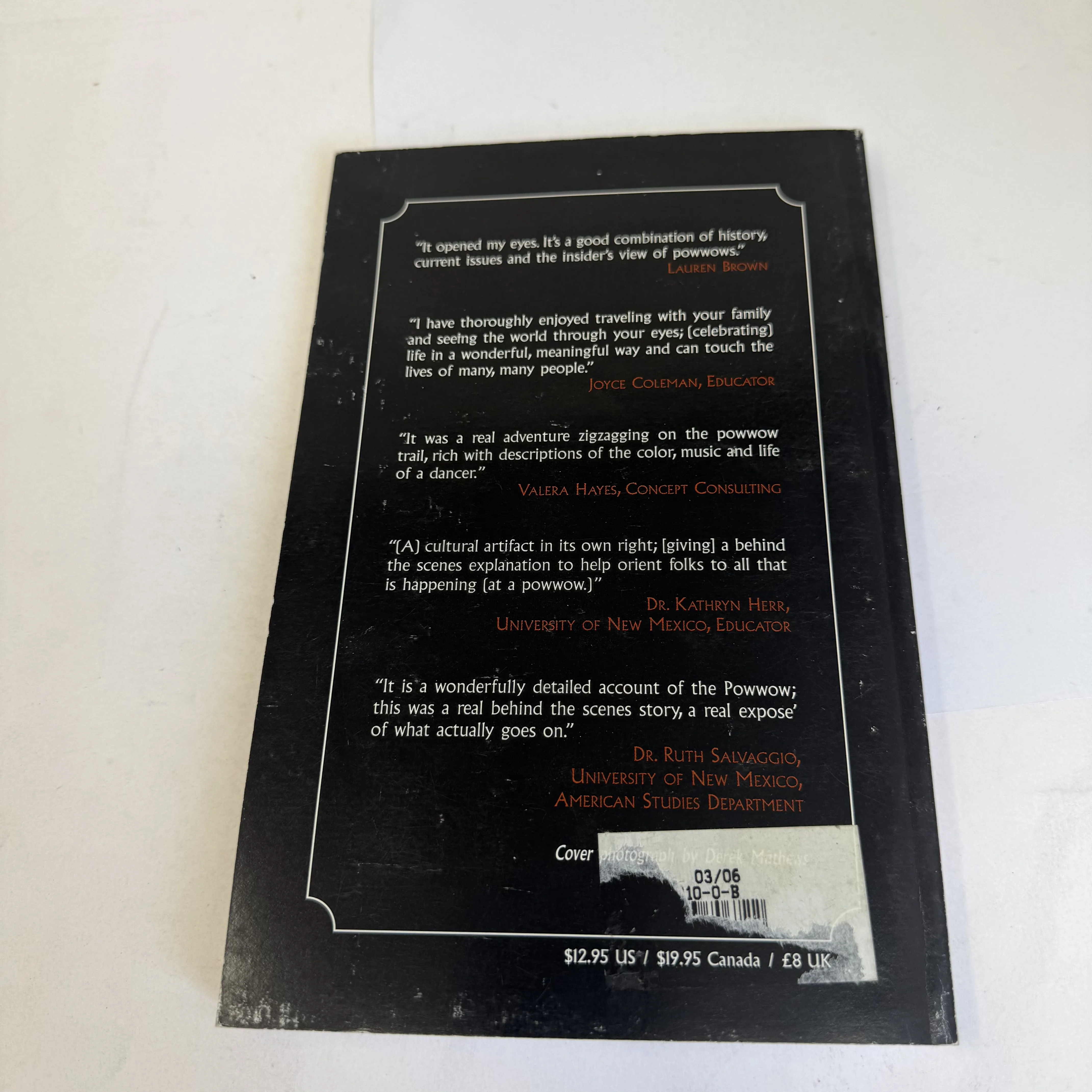 Back cover of A Powwow Summer Across North America — five praise quotes from Lauren Brown, Joyce Coleman, Valera Hayes, Dr. Kathryn Herr (University of New Mexico), and Dr. Ruth Salvaggio (UNM American Studies), with library sticker partially covering cover photo credit