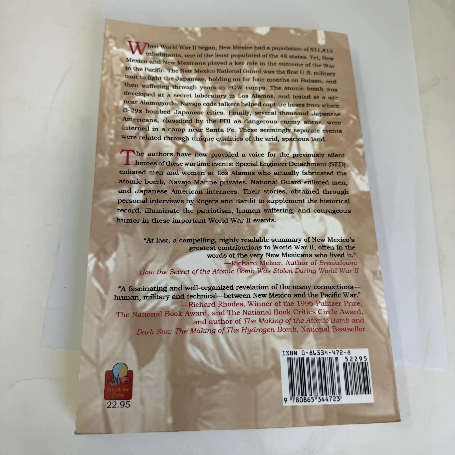 Back cover of Silent Voices of World War II by Rogers and Bartlit, Sunstone Press 2005, featuring endorsement blurbs including praise from Pulitzer Prize-winning author Richard Rhodes author of The Making of the Atomic Bomb, photographed at the New Mexico Literacy Project sorting desk in Albuquerque