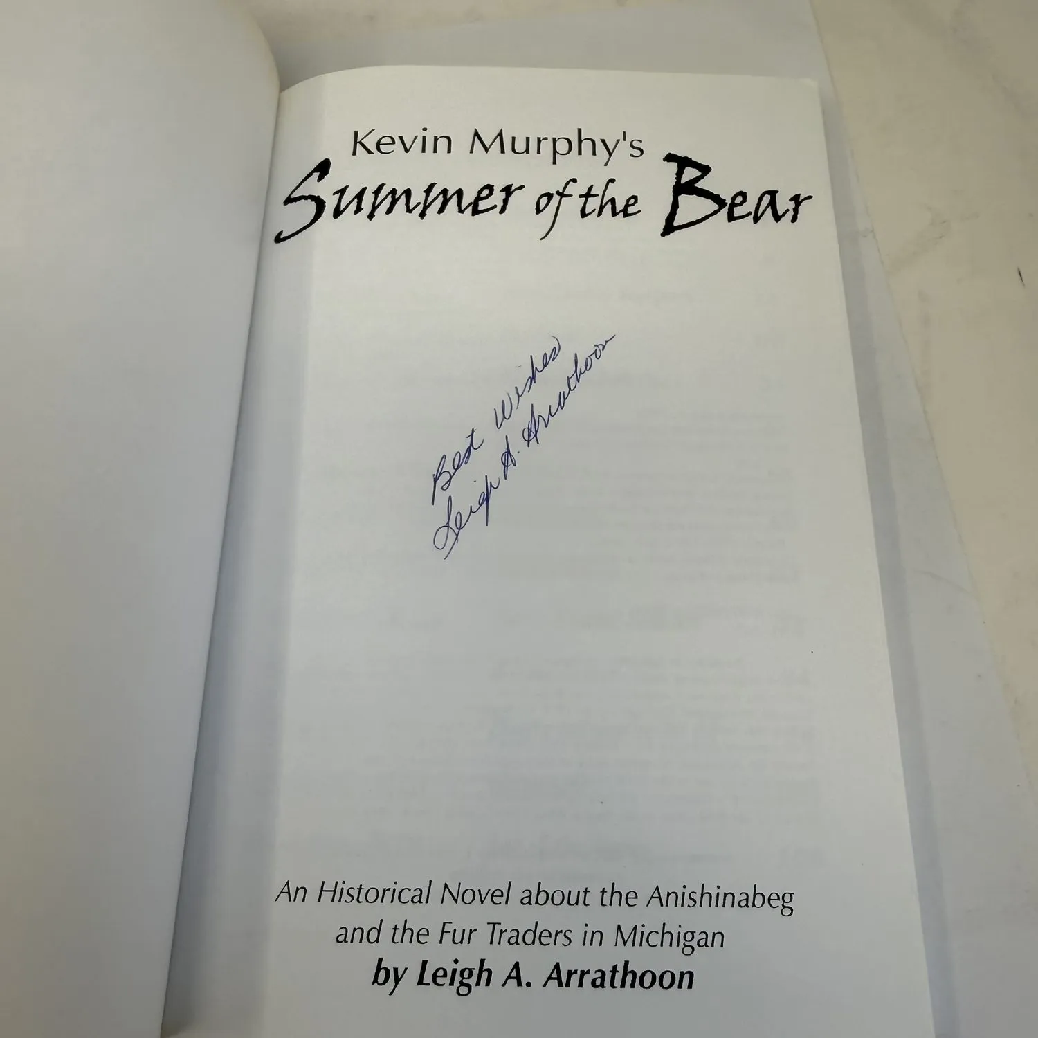 Signed title page of Summer of the Bear by Leigh A. Arrathoon, inscribed Best Wishes Leigh A. Arrathoon, Paint Creek Press Rochester Michigan 2005 first printing. Young adult historical fiction about the Anishinabeg Ojibwe and French Canadian voyageurs. Signed copy found in a New Mexico estate cleanout by the New Mexico Literacy Project.