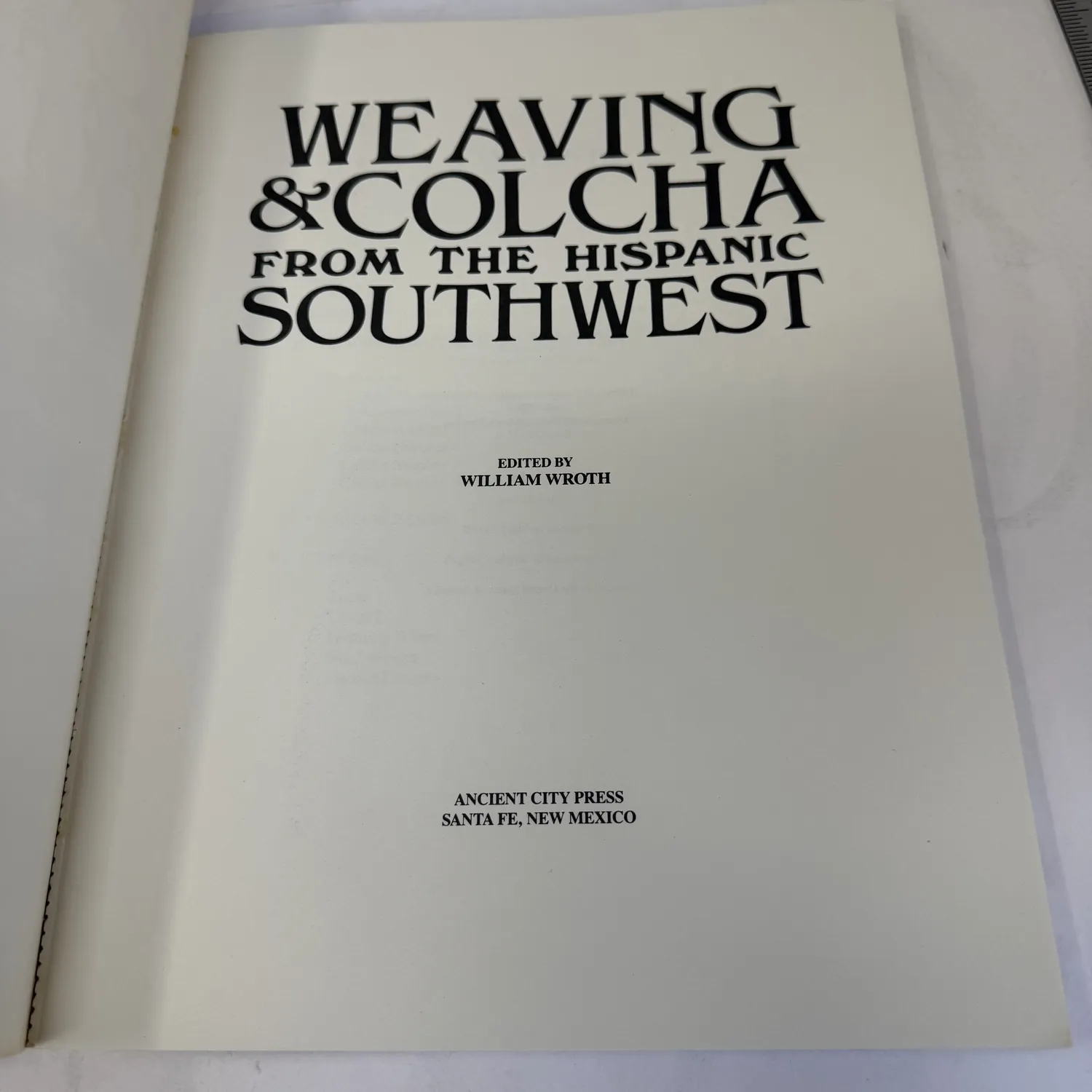 Title page of Weaving and Colcha from the Hispanic Southwest showing full title, Edited by William Wroth, Ancient City Press Santa Fe New Mexico imprint