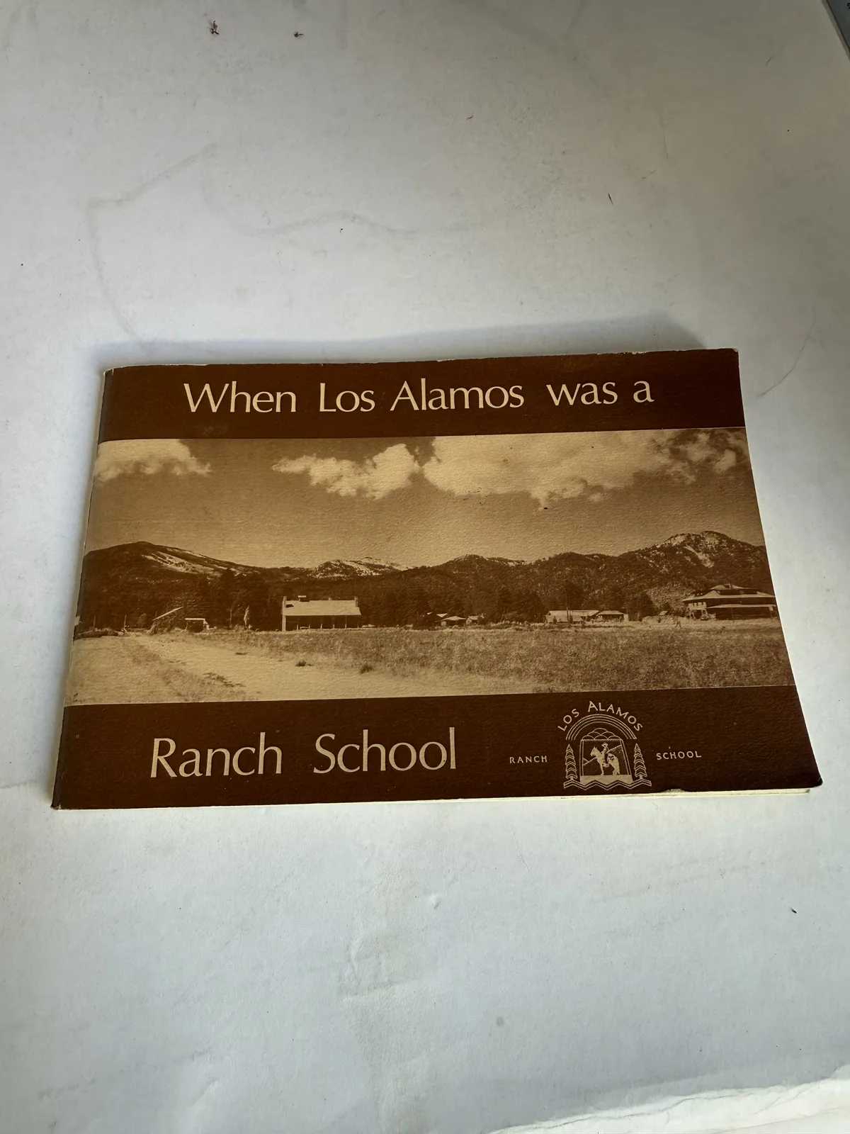 Sepia cover of When Los Alamos was a Ranch School, Los Alamos Historical Society, showing the Pajarito Plateau ranch school buildings against the Jemez Mountains, photographed at New Mexico Literacy Project